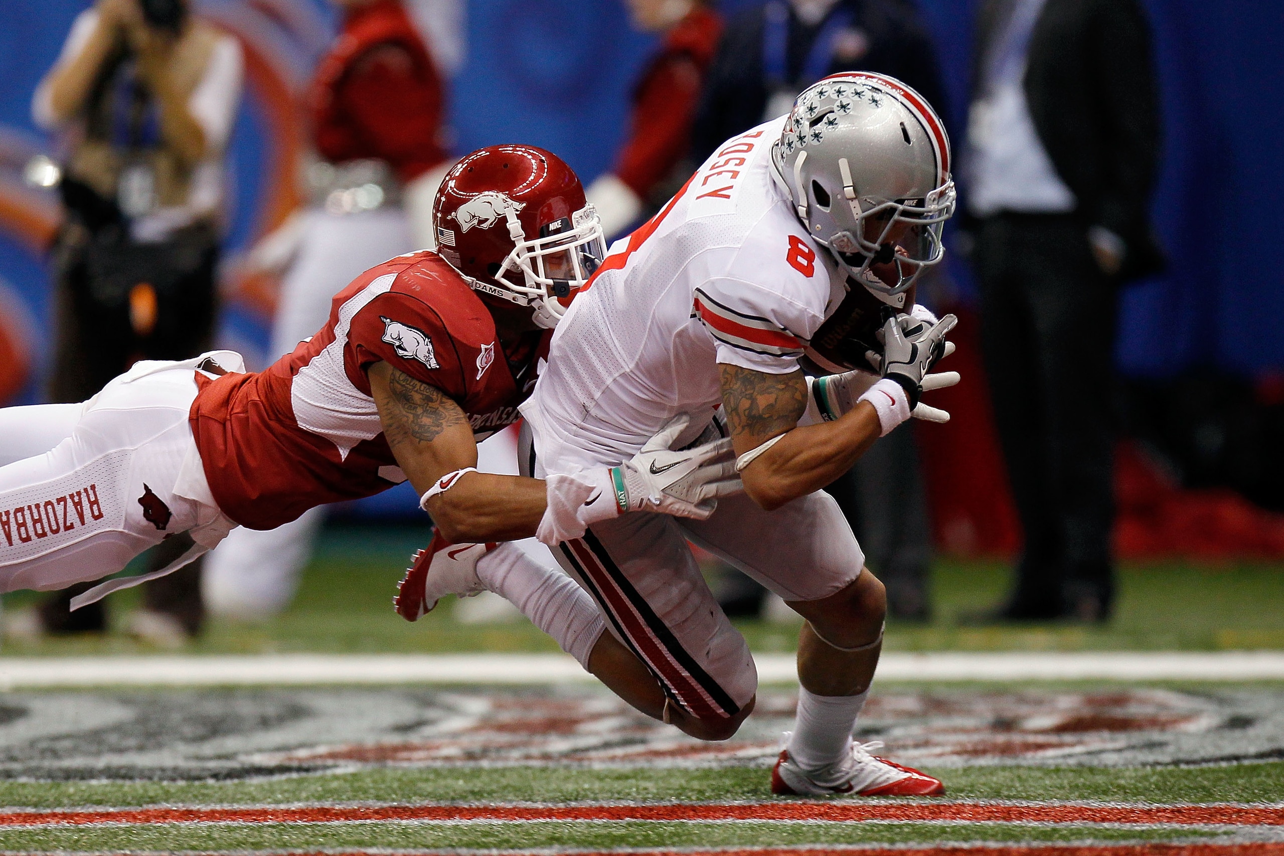NEW ORLEANS, LA - JANUARY 04: DeVier Posey #8 of the Ohio State Buckeyes catches a 43-yard touchdown catch against Tramain Thomas #5 of the Arkansas Razorbacks in the second quarter during the Allstate Sugar Bowl at the Louisiana Superdome on January 4, NEW ORLEANS, LA - JANUARY 04: DeVier Posey #8 of the Ohio State Buckeyes catches a 43-yard touchdown catch against Tramain Thomas #5 of the Arkansas Razorbacks in the second quarter during the Allstate Sugar Bowl at the Louisiana Superdome on January 4,