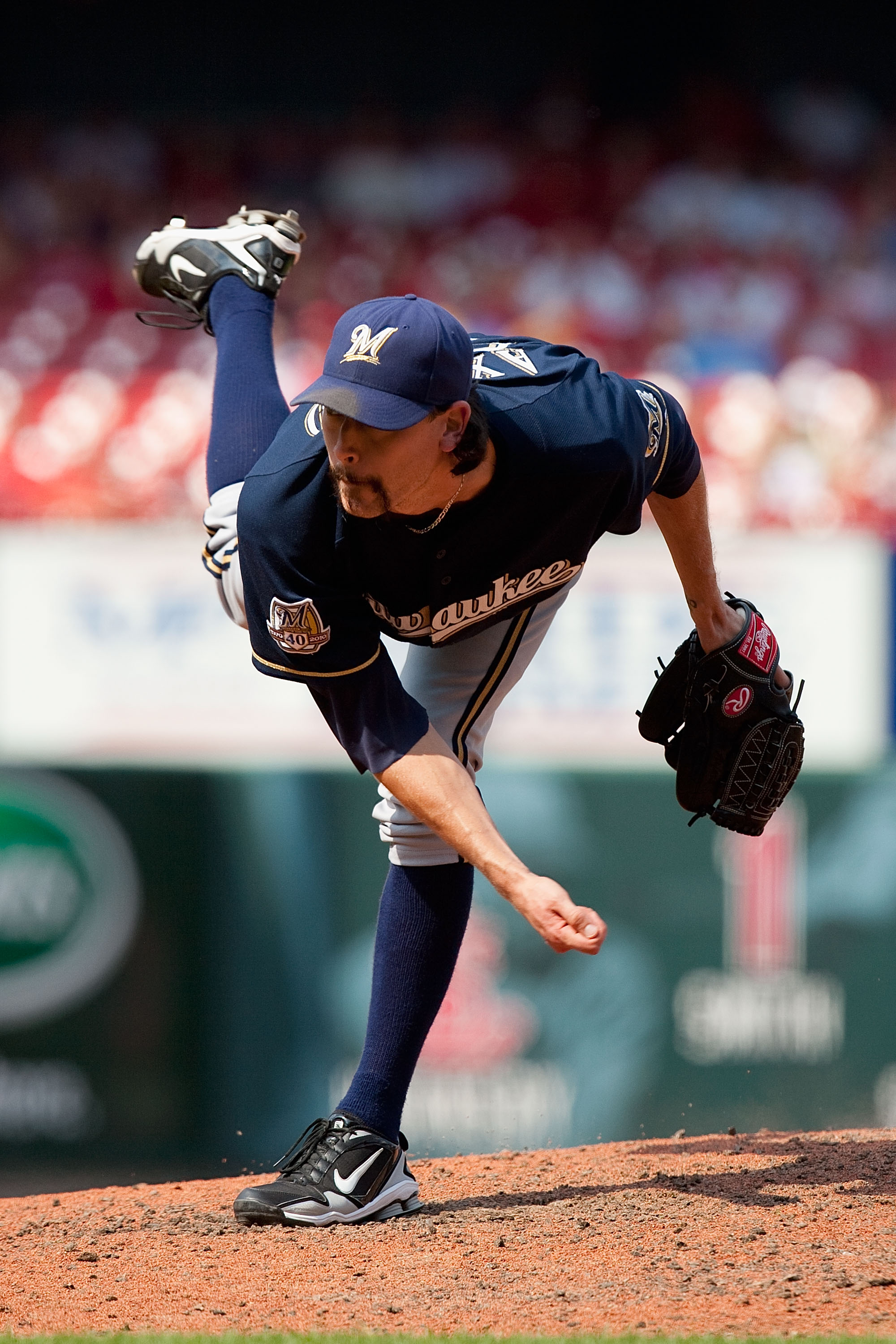ST. LOUIS - AUGUST 18: Relief pitcher John Axford #59 of the Milwaukee Brewers throws against the St. Louis Cardinals at Busch Stadium on August 18, 2010 in St. Louis, Missouri.  The Brewers beat the Cardinals 3-2.  (Photo by Dilip Vishwanat/Getty Images)
