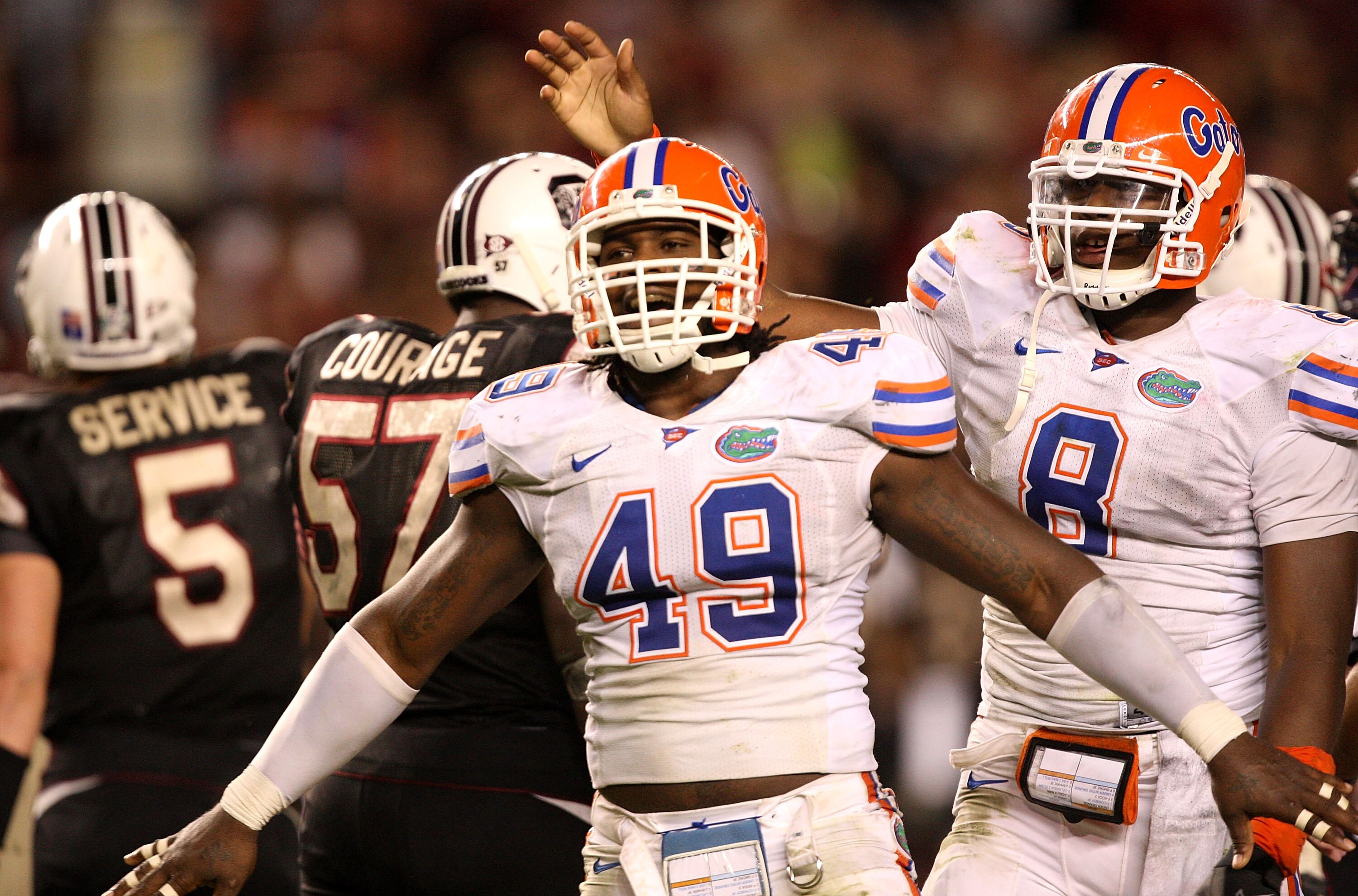 COLUMBIA, SC - NOVEMBER 14:  Jermaine Cunningham #49 and teammate Carlos Dunlap #8 of the Florida Gators react after a defensive stopp against the South Carolina Gamecocks during their game at Williams-Brice Stadium on November 14, 2009 in Columbia, South