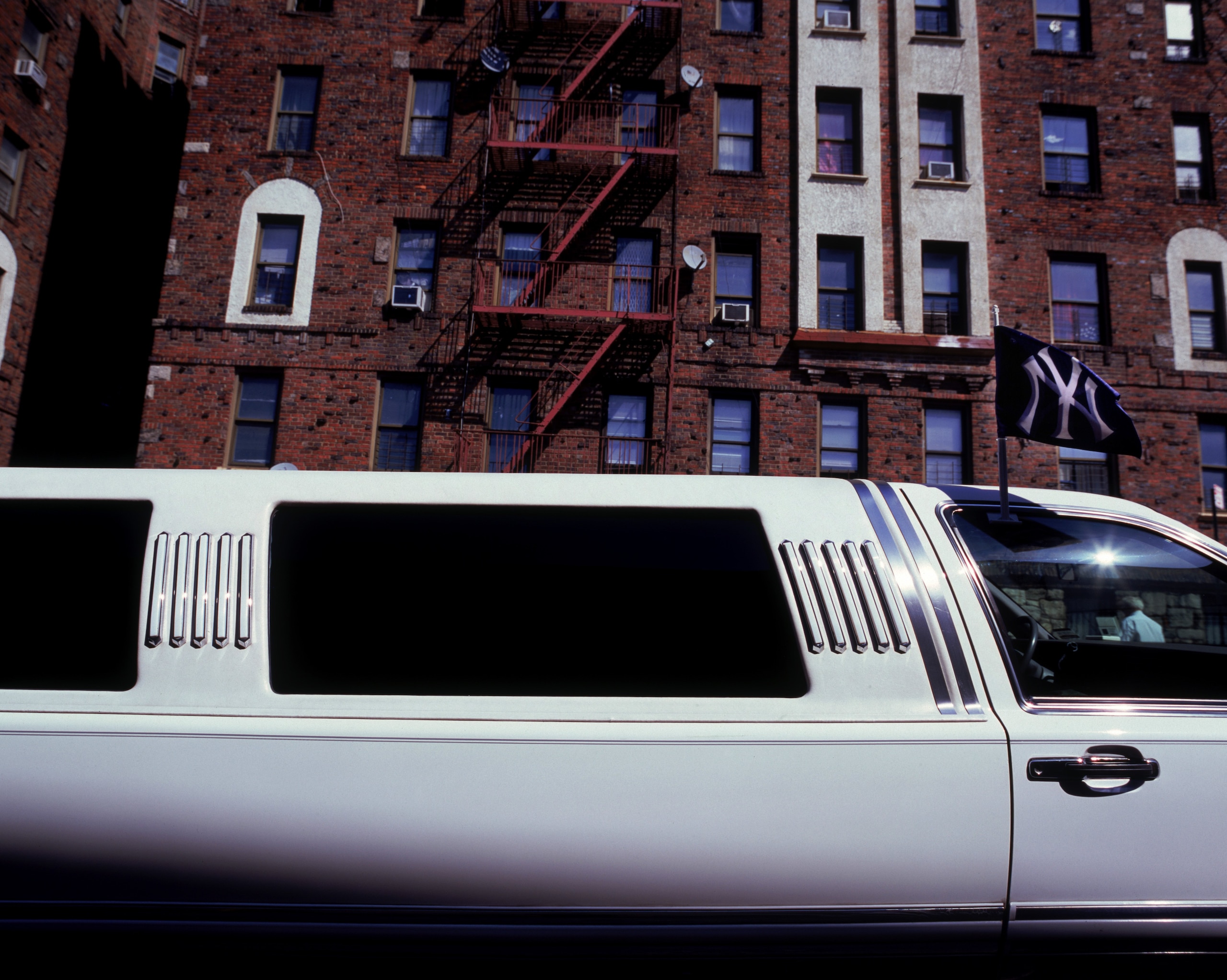 NEW YORK - SEPTEMBER 20: A New York Yankees flag waves on a limousine parked in the streets behind Yankee Stadium on September 20, 2008 in the Bronx borough of New York City. The Yankees are playing their final season in the 85 year old ball park and plan