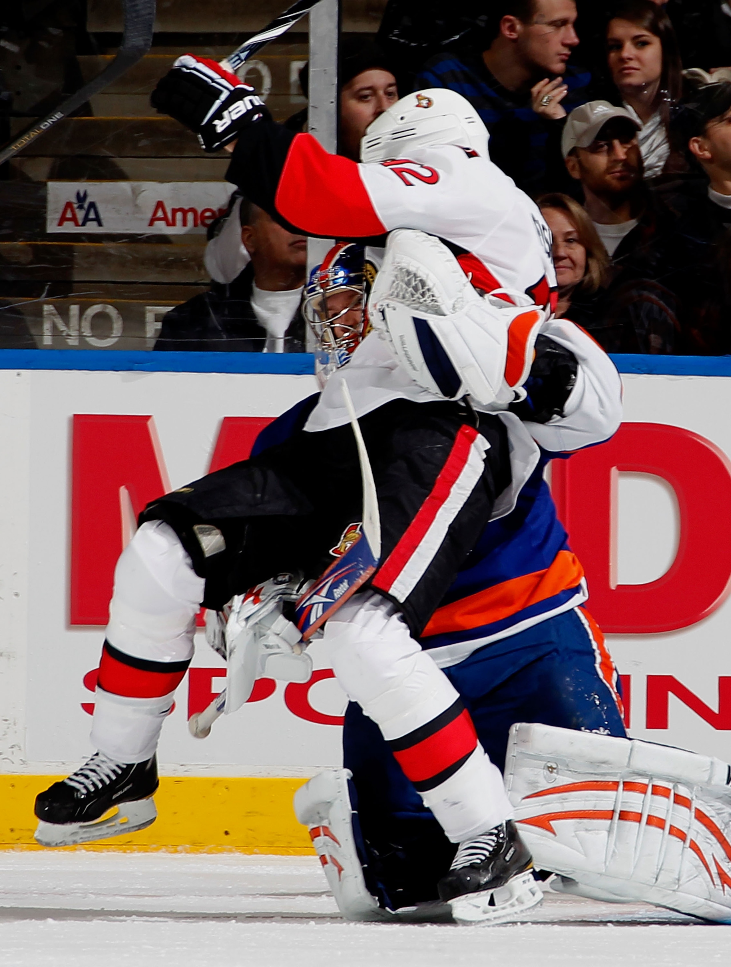 UNIONDALE, NY - JANUARY 13:  Mike Fisher #12 of the Ottawa Senators collides with Goalie Nathan Lawson #52 of the New York Islanders during the second period of an NHL hockey game at the Nassau Coliseum on January 13, 2011 in Uniondale, New York.  (Photo