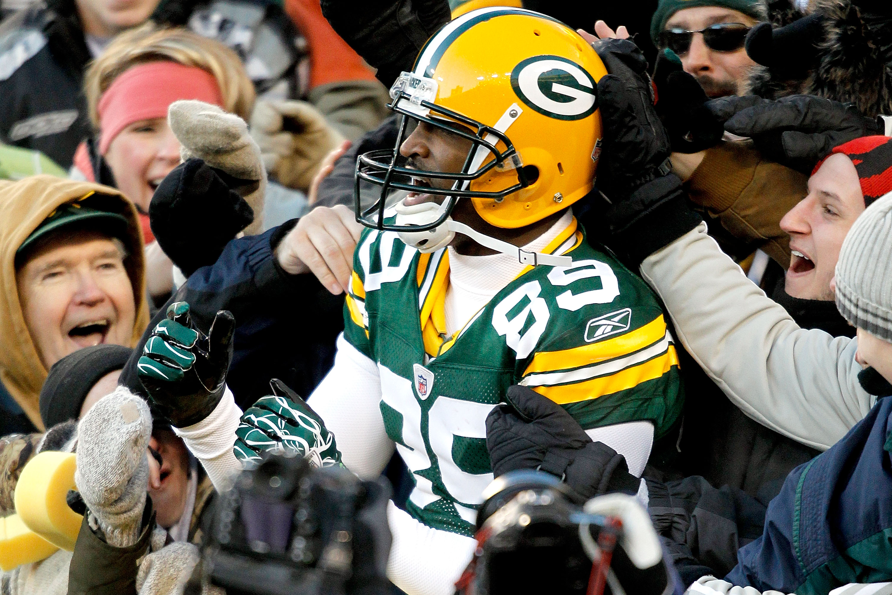 GREEN BAY, WI - DECEMBER 26:  James Jones #89 of the Green Bay Packers leaps into the stands after scoring a touchdown against the New York Giants at Lambeau Field on December 26, 2010 in Green Bay, Wisconsin.  (Photo by Matthew Stockman/Getty Images)