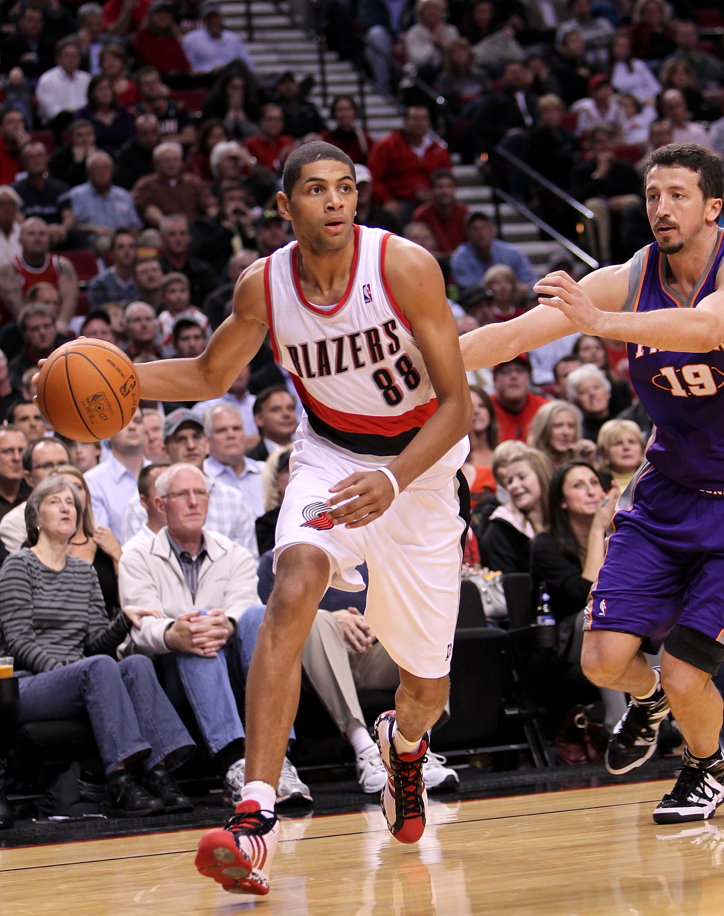 PORTLAND, OR - OCTOBER 26:  Nicolas Batum #88 dribbles the ball agaionst Hedo Tukgolu #19 of the Portland Trail Blazers of the Phoeninx Suns on October 26, 2010 at the Rose Garden in Portland, Oregon.  NOTE TO USER: User expressly acknowledges and agrees