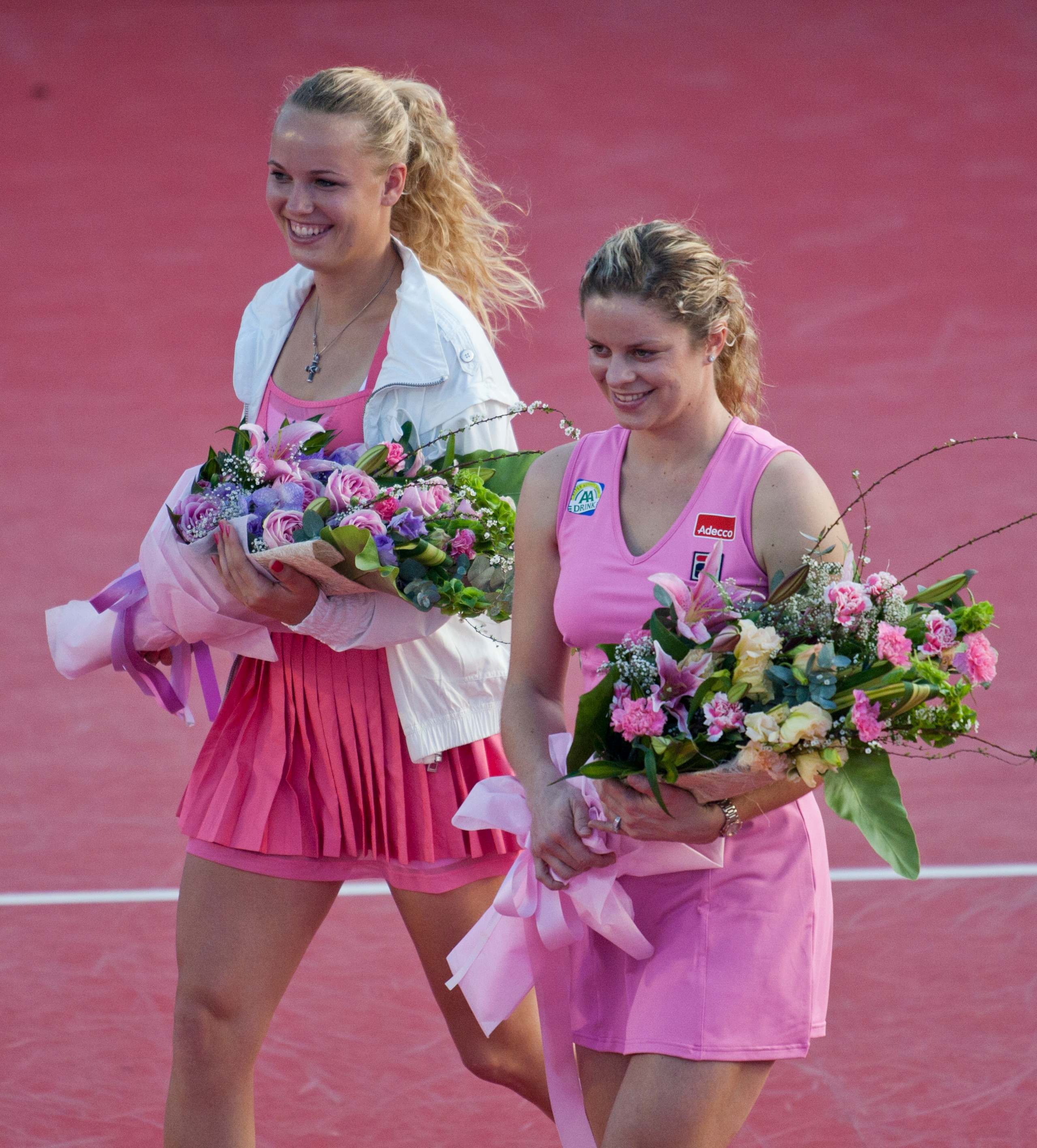 HUA HIN, THAILAND - JANUARY 01:    Caroline Wozniacki of Denmark and Kim Clijsters of Belgium hold the bouquets of flowers before their exhibition match at Centenial Park on January 1, 2011 in Hua Hin, Thailand.  (Photo by Athit Perawongmetha/Getty Images