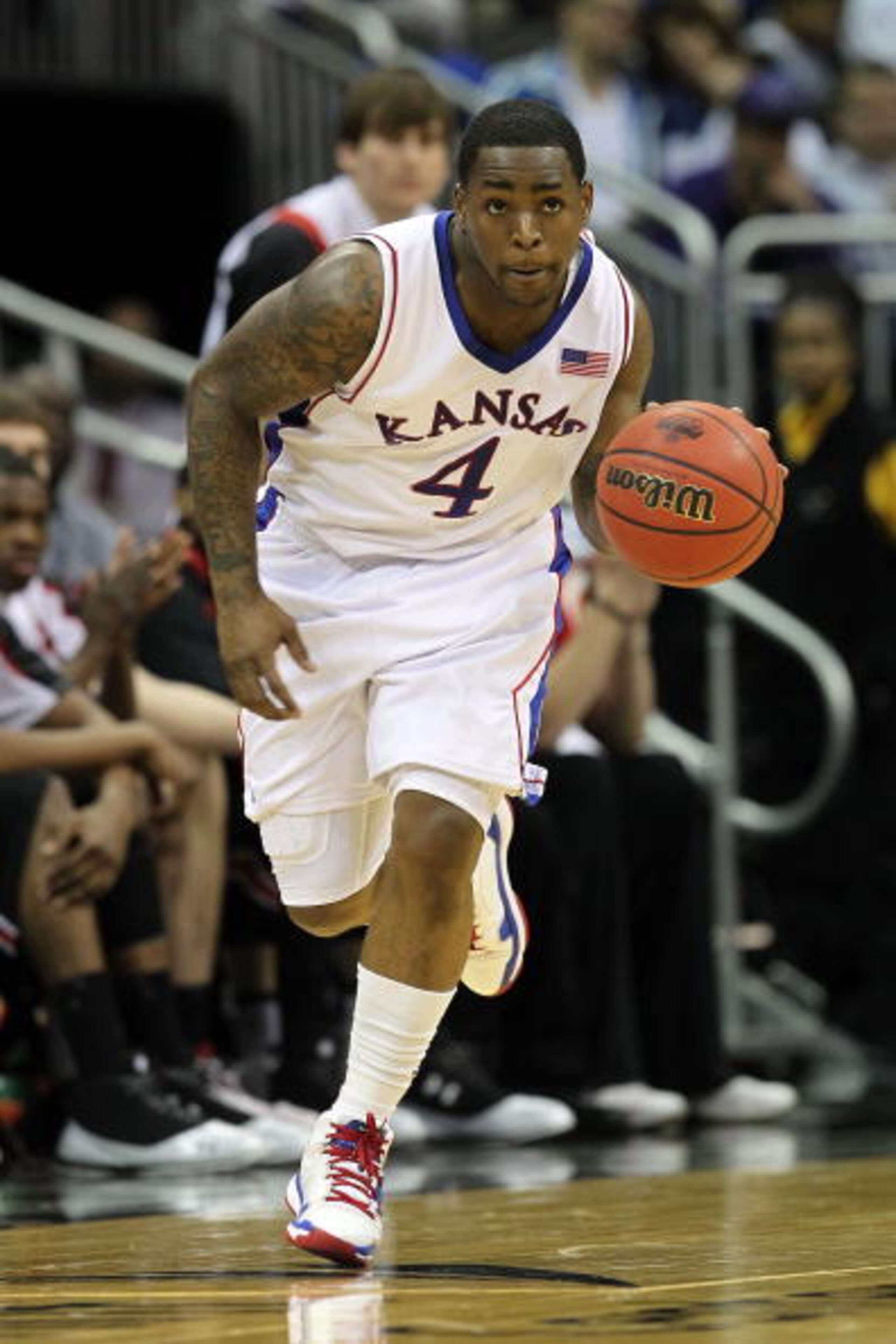 KANSAS CITY, MO - MARCH 11:  Sherron Collins #4 of the Kansas Jayhawks moves the ball while taking on the Texas Tech Red Raiders during the quarterfinals of the 2010 Phillips 66 Big 12 Men's Basketball Tournament at the Sprint Center on March 11, 2010 in 