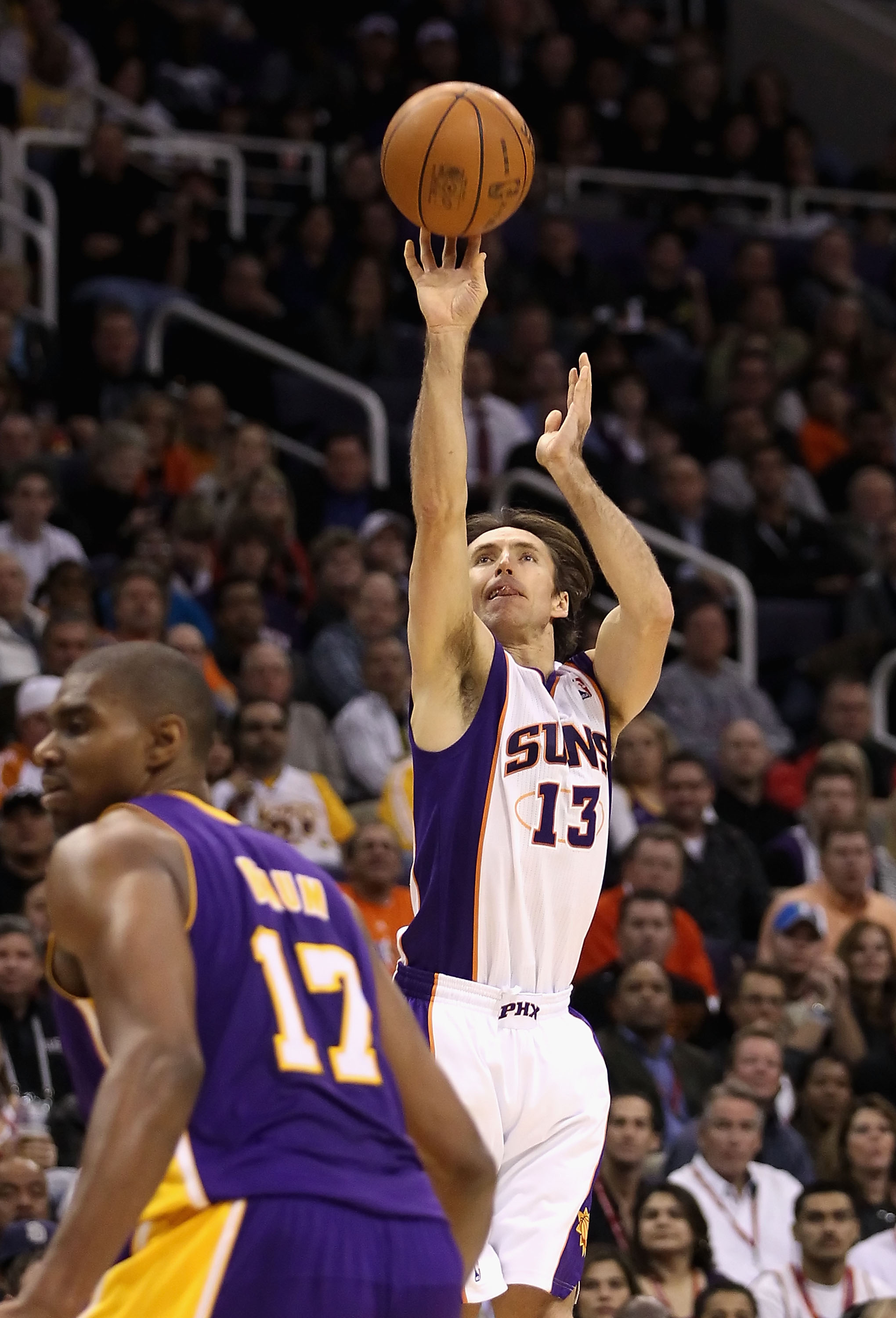 PHOENIX - JANUARY 05: Steve Nash #13 of the Phoenix Suns puts up a shot over Andrew Bynum #17 of the Los Angeles Lakers during the NBA game at US Airways Center on January 5, 2011 in Phoenix, Arizona. NOTE TO USER: User expressly acknowledges and agrees t