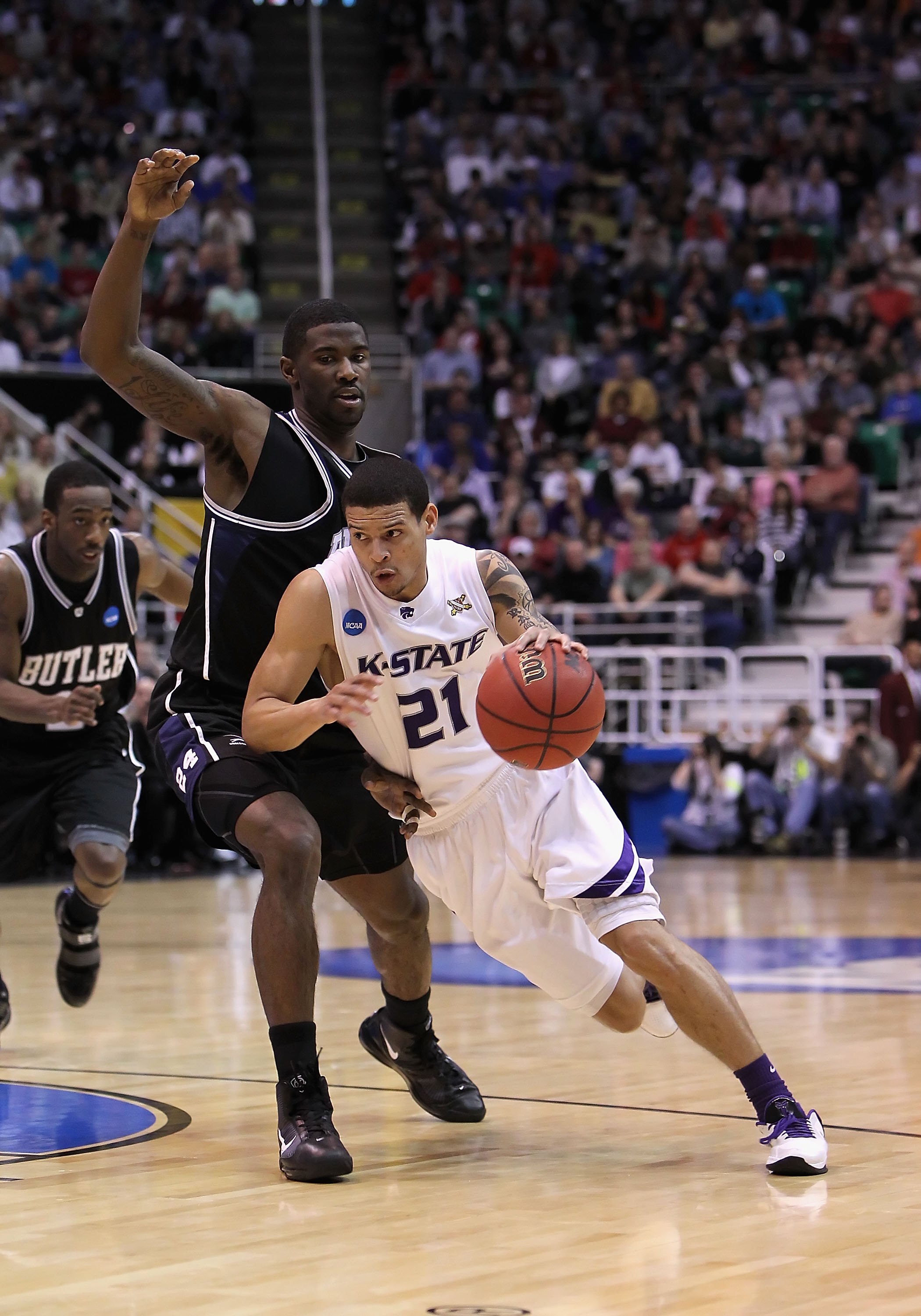 SALT LAKE CITY - MARCH 27:  Denis Clemente #21 of the Kansas State Wildcats drives the ball against the Butler Bulldogs during the west regional final of the 2010 NCAA men's basketball tournament at the Energy Solutions Arena on March 27, 2010 in Salt Lak