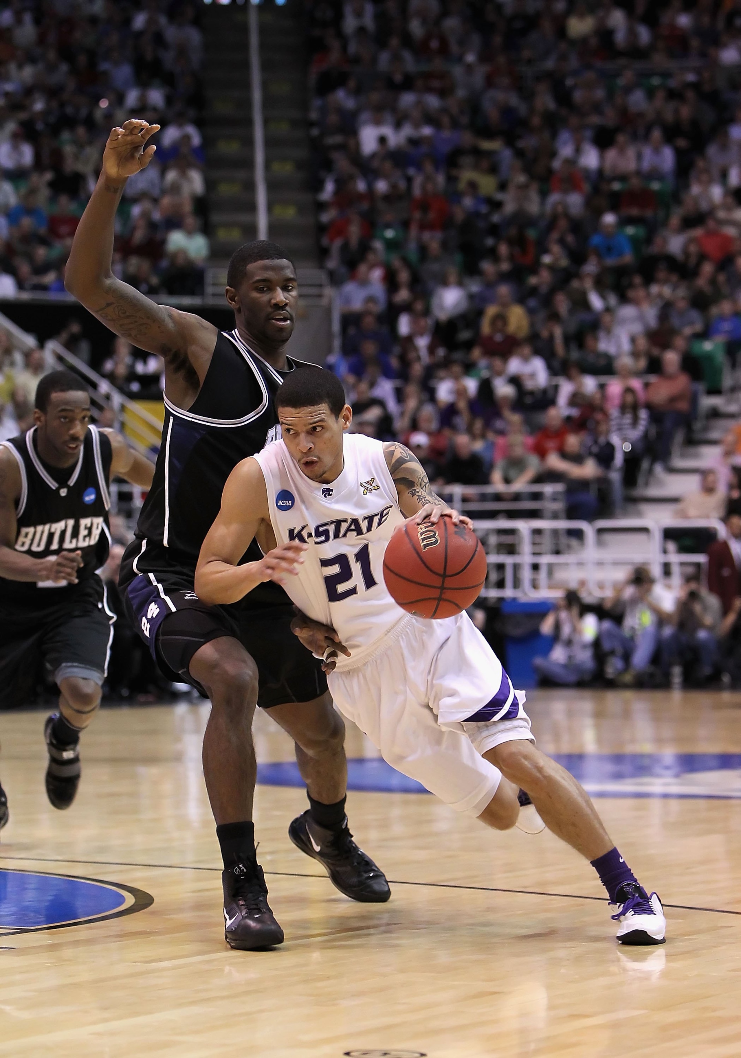 SALT LAKE CITY - MARCH 27:  Denis Clemente #21 of the Kansas State Wildcats drives the ball against the Butler Bulldogs during the west regional final of the 2010 NCAA men's basketball tournament at the Energy Solutions Arena on March 27, 2010 in Salt Lak