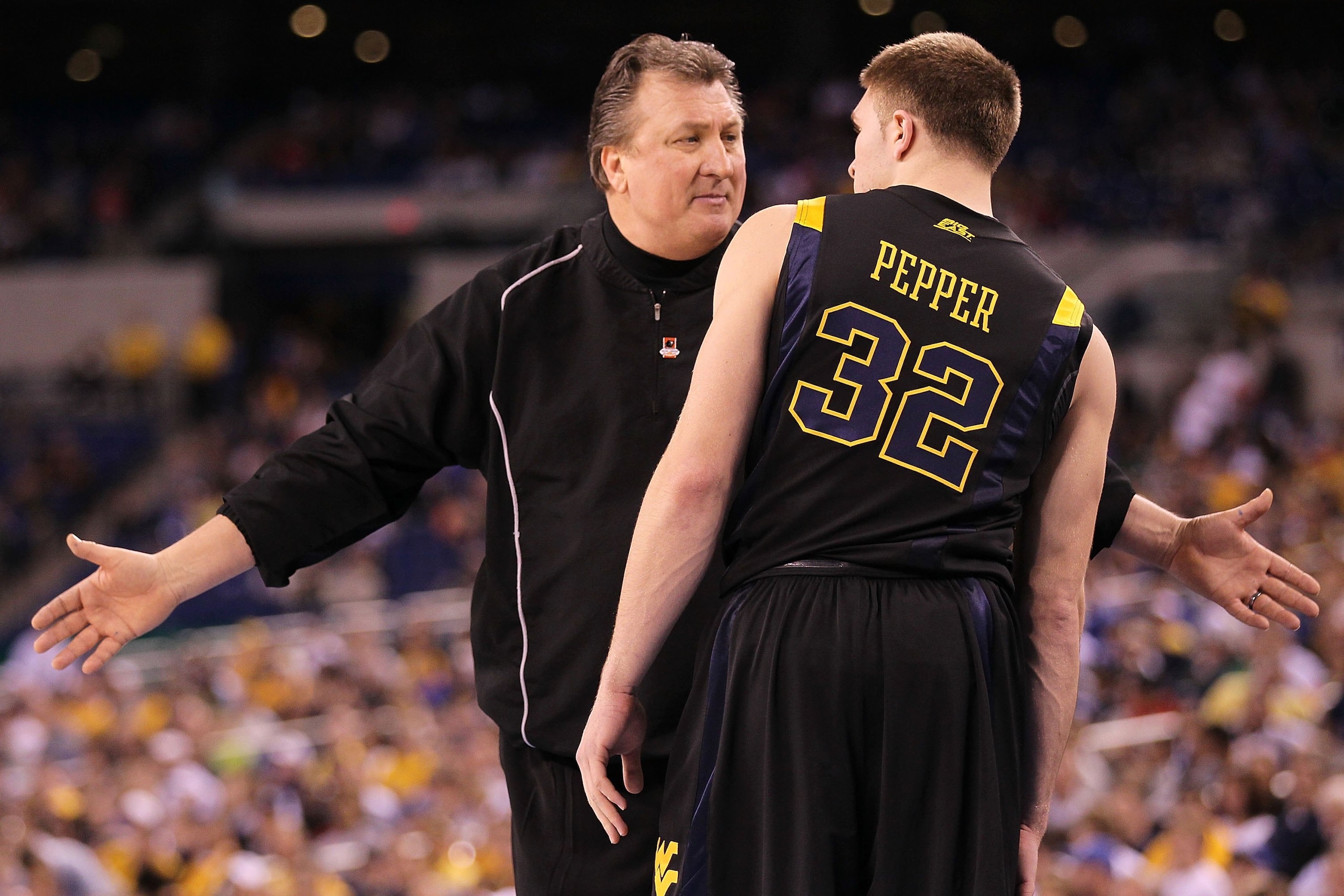 INDIANAPOLIS - APRIL 03: Head coach Bob Huggins of the West Virginia Mountaineers talks with Dalton Pepper #32 while taking on the Duke Blue Devils during the National Semifinal game of the 2010 NCAA Division I Men's Basketball Championship at Lucas Oil INDIANAPOLIS - APRIL 03: Head coach Bob Huggins of the West Virginia Mountaineers talks with Dalton Pepper #32 while taking on the Duke Blue Devils during the National Semifinal game of the 2010 NCAA Division I Men's Basketball Championship at Lucas Oil