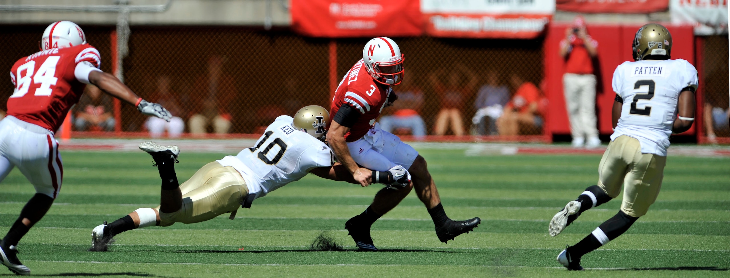 LINCOLN, NE - SEPTEMBER 11: Nebraska Cornhuskers quarterback Taylor Martinez #3 runs from Idaho Vandals safety Shiloh Keo #10 and Idaho Vandals cornerback Kenneth Patten #2 during second half action of their game at Memorial Stadium on September 4, 2010 i