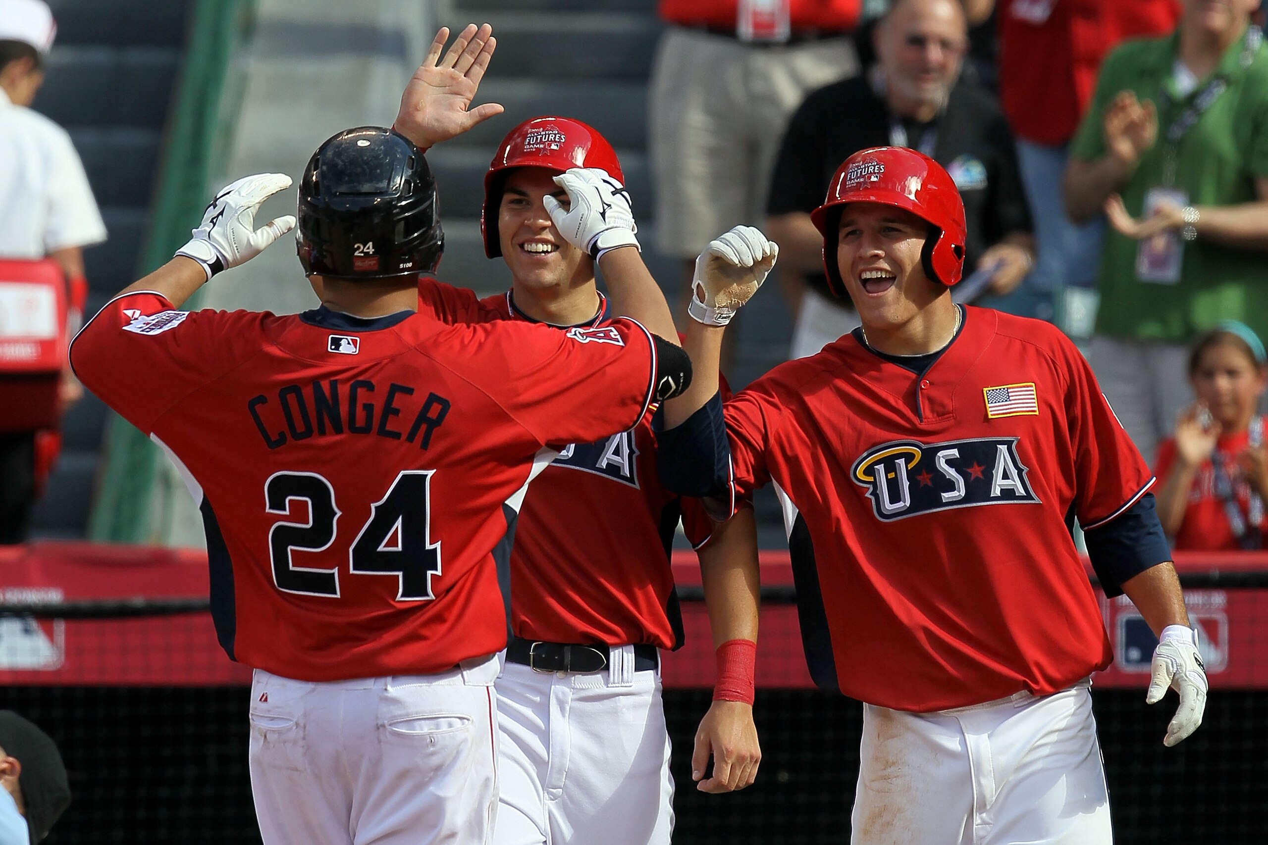 ANAHEIM, CA - JULY 11: U.S. Futures All-Star Hank Conger #24 of the Los Angeles Angels of Anaheim (L) celebrates with teammates U.S. Futures All-Star Eric Hosmer #30 of the Kansas City Royals (C) and U.S. Futures All-Star Mike Trout #20 of the Los Angele ANAHEIM, CA - JULY 11: U.S. Futures All-Star Hank Conger #24 of the Los Angeles Angels of Anaheim (L) celebrates with teammates U.S. Futures All-Star Eric Hosmer #30 of the Kansas City Royals (C) and U.S. Futures All-Star Mike Trout #20 of the Los Angele