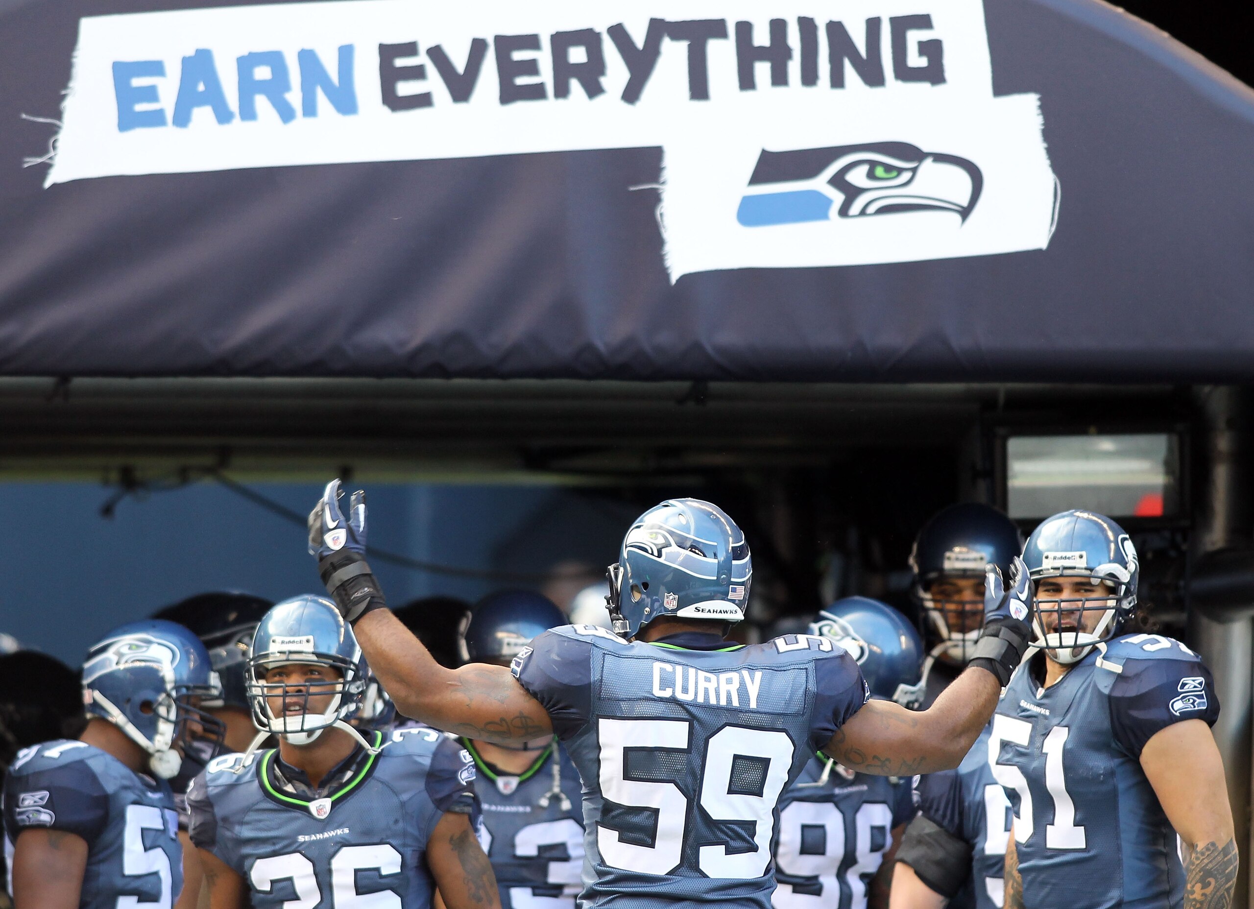 SEATTLE, WA - JANUARY 08:  Aaron Curry #59 of the Seattle Seahawks gathers his teammates at the beginning of player introductions before taking on the New Orleans Saints in the 2011 NFC wild-card playoff game at Qwest Field on January 8, 2011 in Seattle,