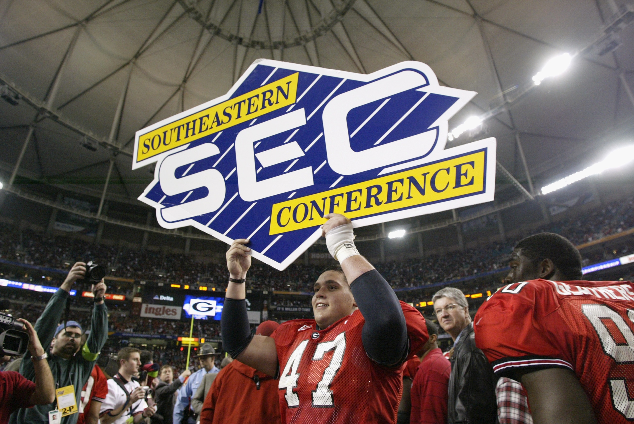 ATLANTA - DECEMBER 7:  Defensive end David Pollack #47 of the University of Georgia Bulldogs holds an SEC sign, prior to the SEC Championship game against the University of Arkansas Razorbacks at the Georgia Dome on December 7, 2002 in Atlanta, Georgia. T