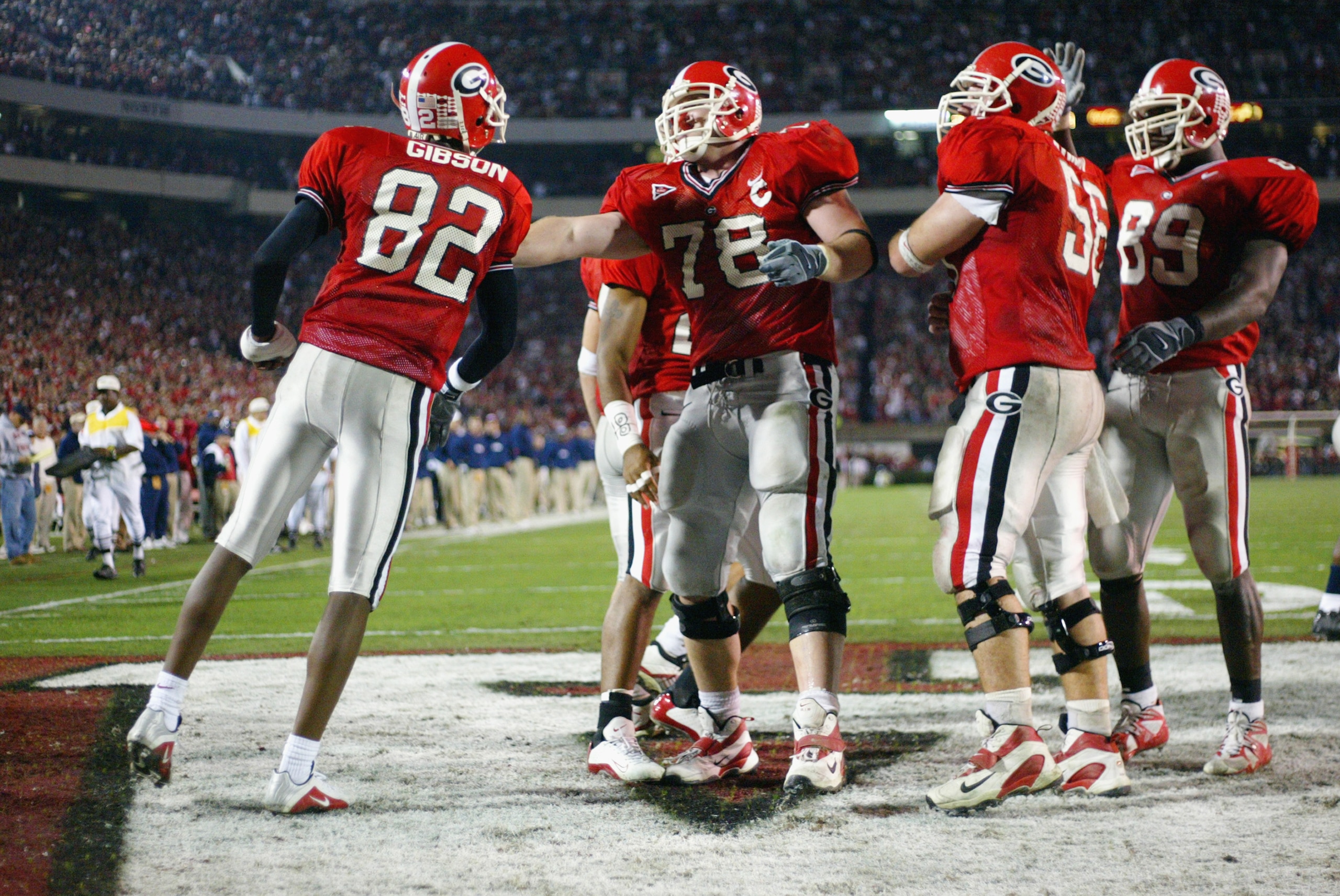 ATHENS, GA - NOVEMBER 9:  Fred Gibson #82 and Jon Stinchcomb #78 of the University of Georgia Bulldogs celebrate during the SEC game against the University of Mississippi Rebels at Sanford Stadium on November 9, 2002 in Athens, Georgia.  Georgia won 31-17