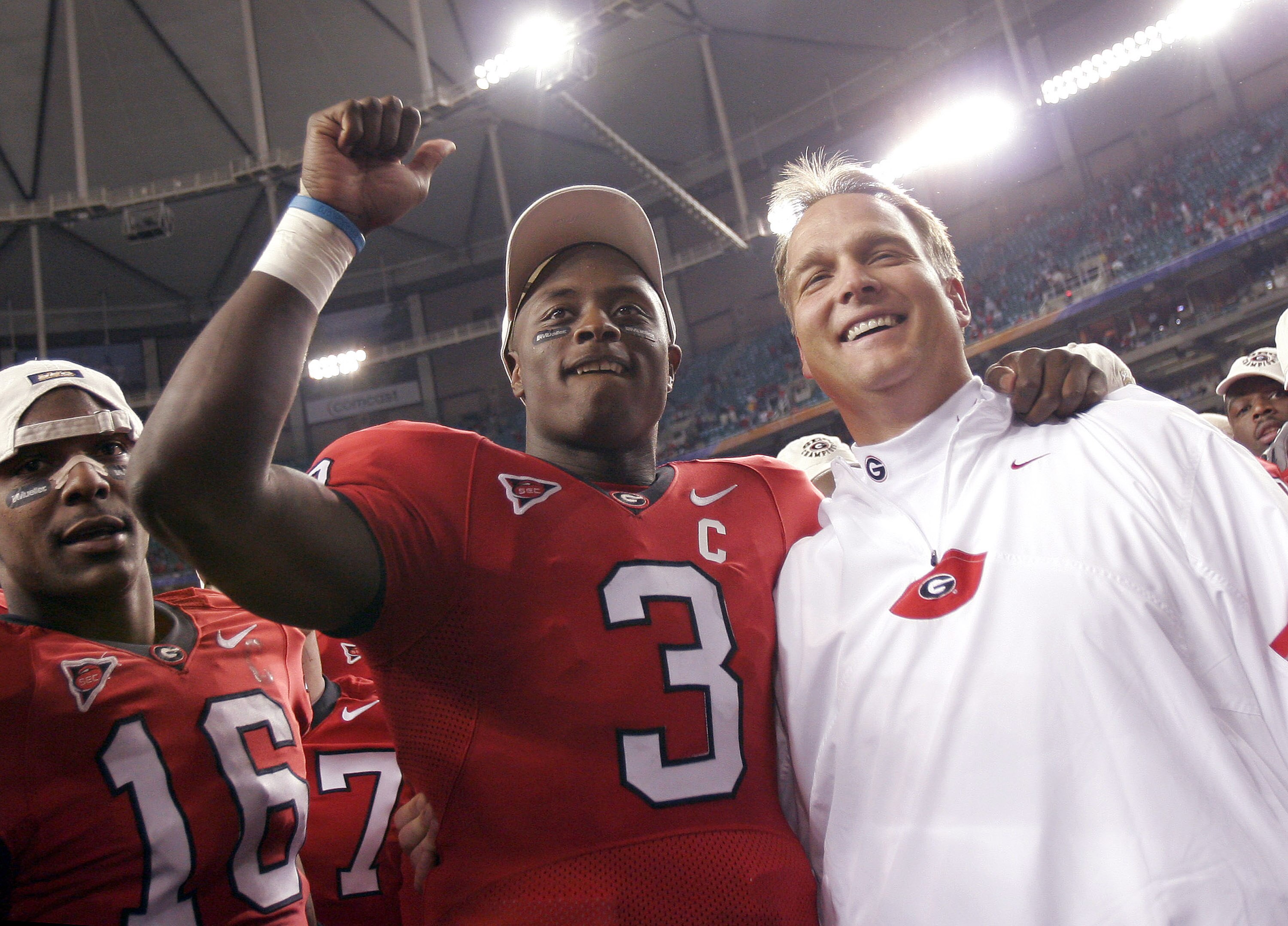 ATLANTA - DECEMBER 3:  Quarterback D.J. Shockley #3 and coach Mark Richt of the Georgia Bulldogs celebrate after a 34-14 win over the Louisiana State University Tigers during the 2005 SEC Football Championship Game on December 3, 2005 at the Georgia Dome 
