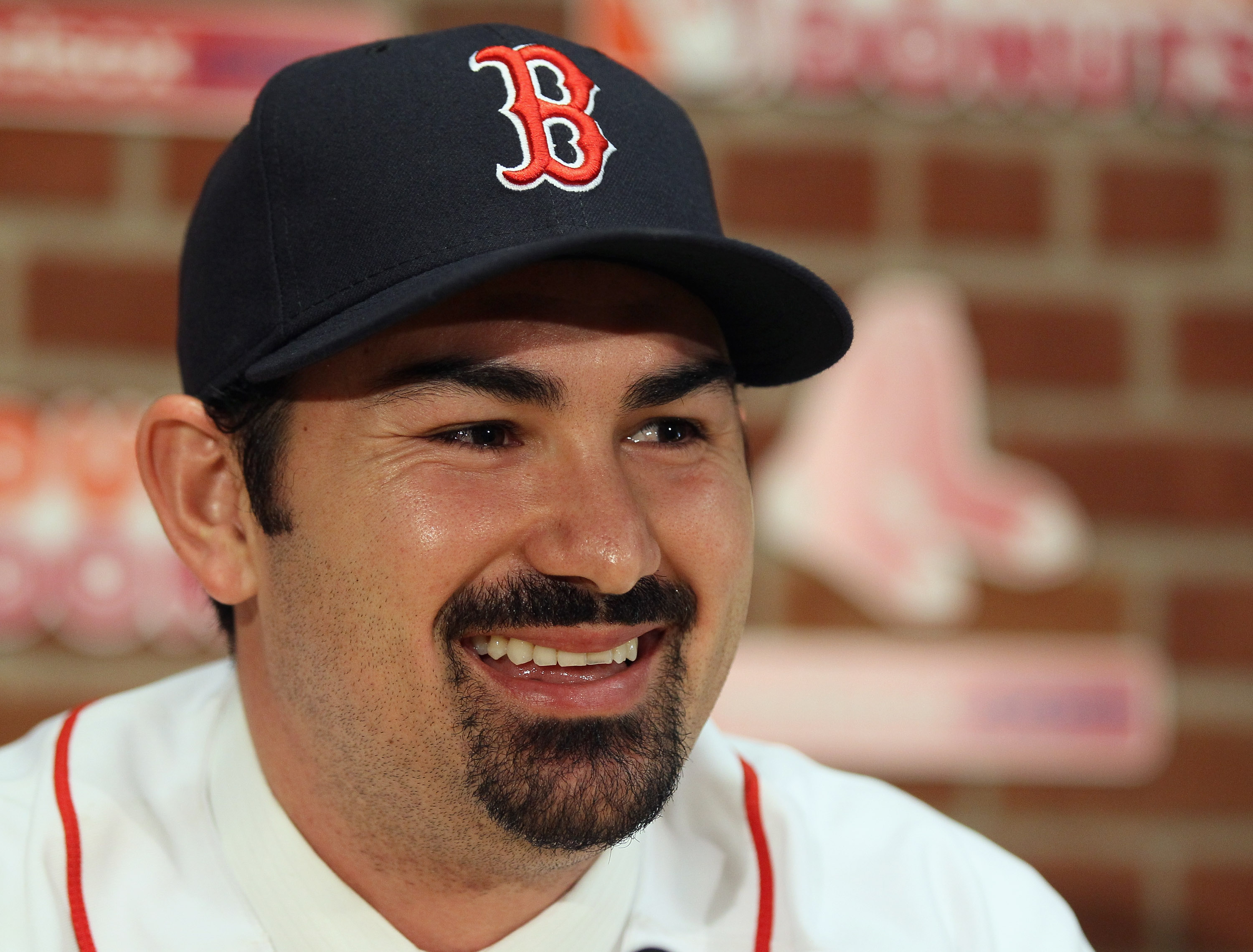 BOSTON, MA - DECEMBER 06:  Adrian Gonzalez answers questions during a press conference to announce his signing with the Boston Red Sox on December 6,  2010 at Fenway Park in Boston, Massachusetts.  (Photo by Elsa/Getty Images)