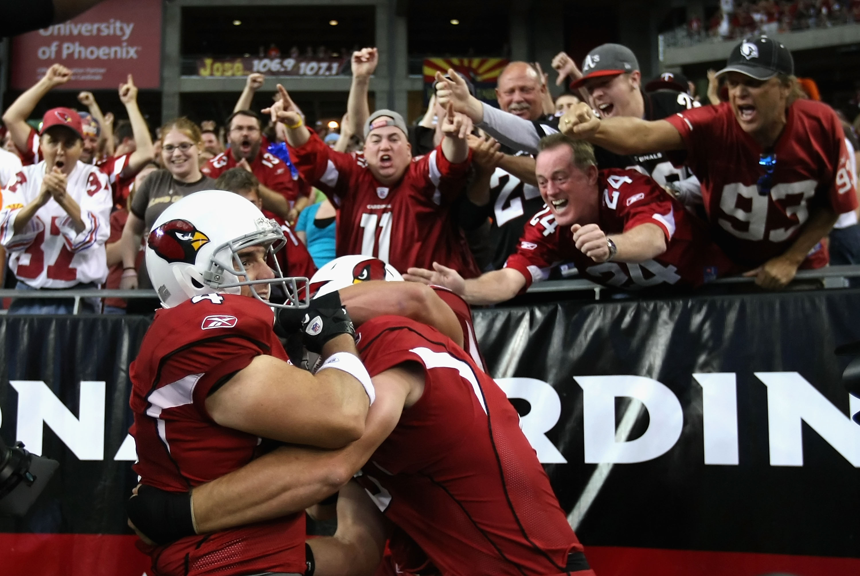 GLENDALE, AZ - DECEMBER 12:  Kicker Jay Feely #4 of the Arizona Cardinals celebrates with teamamtes and fans after scoring on a 5 yard rushing touchdown against the Denver Broncos during the second quarter of the NFL game at the University of Phoenix Stad