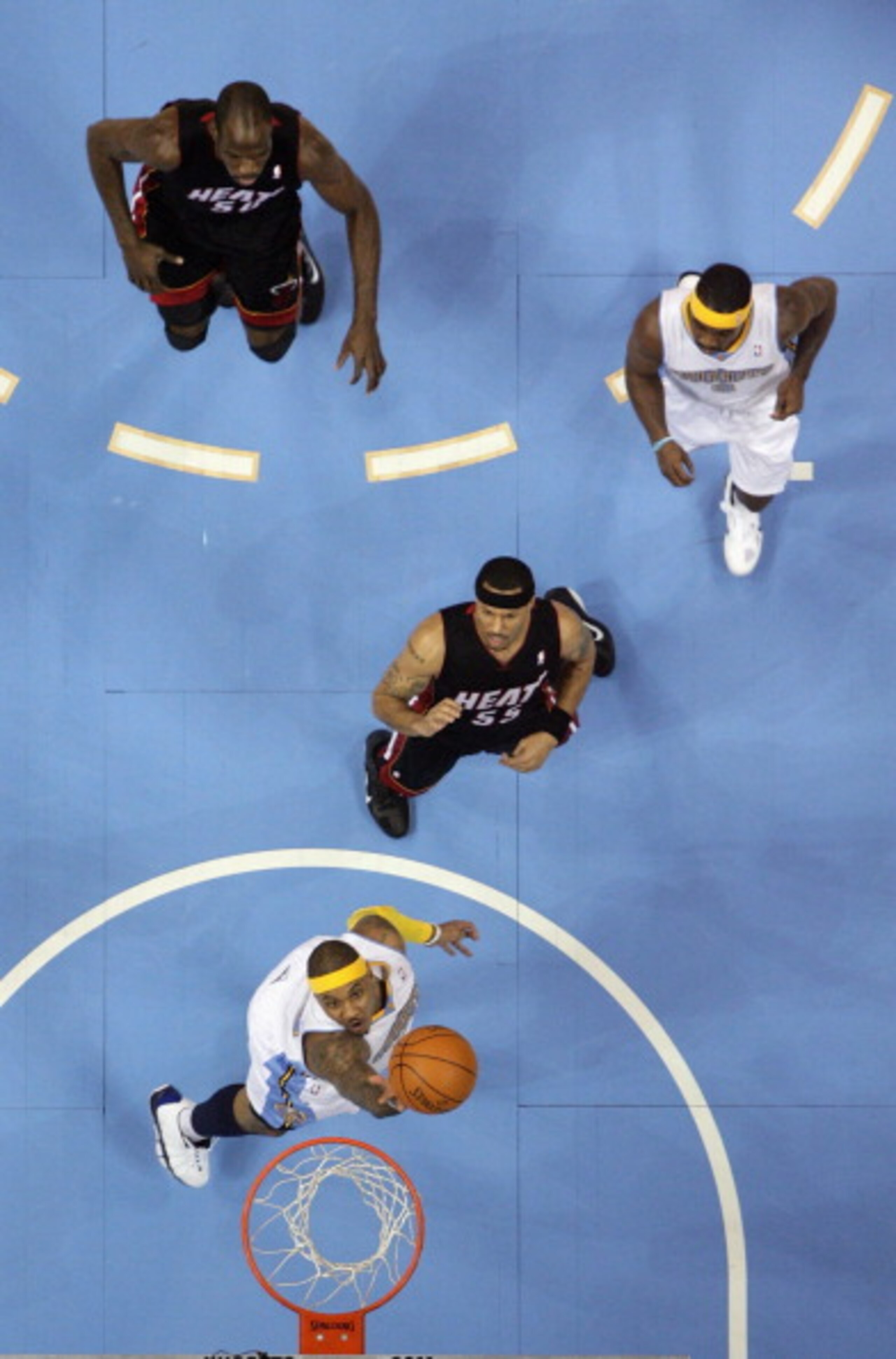 DENVER, CO - JANUARY 13:  Carmelo Anthony #15 of the Denver Nuggets lays up a shot in front of Eddie House #55 of the Miami Heat as Ty Lawson #3 of the Nuggets and Joel Anthony #50 of the Heat follow the play at the Pepsi Center on January 13, 2011 in Den