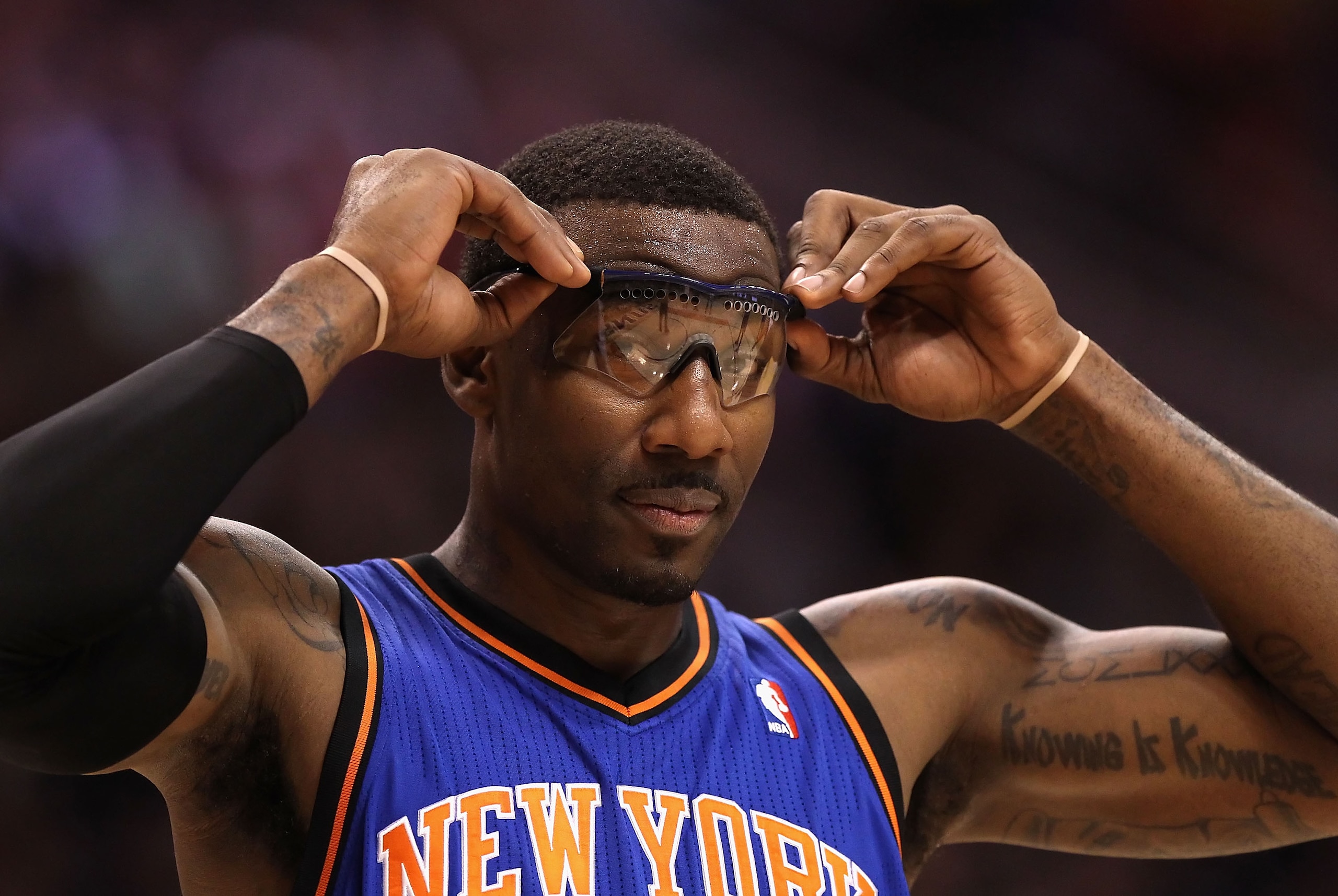 PHOENIX - JANUARY 07:  Amar'e Stoudemire #1 of the New York Knicks adjusts his glasses during the NBA game against the Phoenix Suns at US Airways Center on January 7, 2011 in Phoenix, Arizona.  NOTE TO USER: User expressly acknowledges and agrees that, by