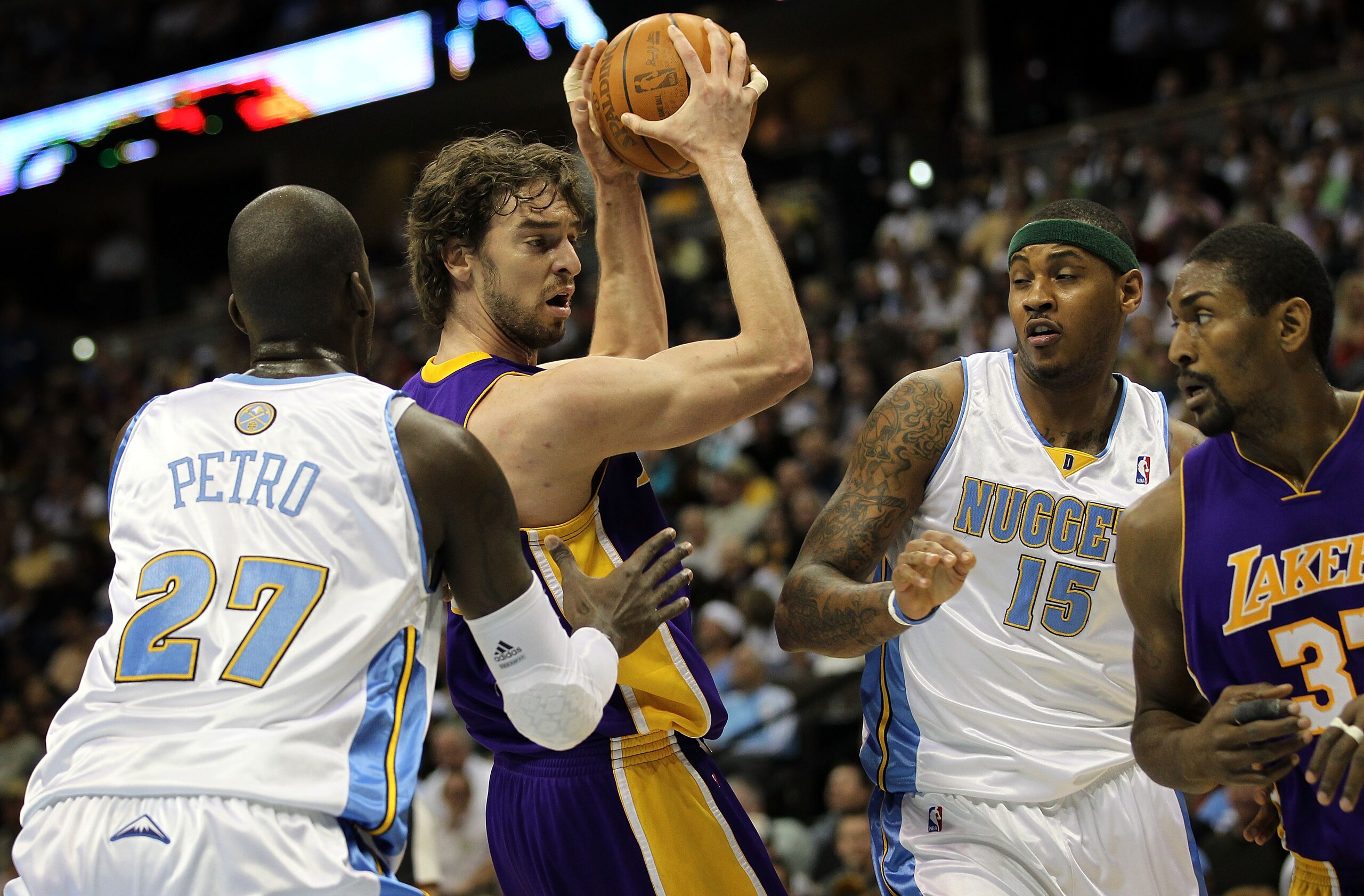 DENVER - APRIL 08:  Pau Gasol #16 of the Los Angeles Lakers controls the ball as Johan Petro #27 of the Denver Nuggets defends while Carmelo Anthony #15 of the Nuggets defends against Ron Artest #37 of the Lakers during NBA action at the Pepsi Center on A