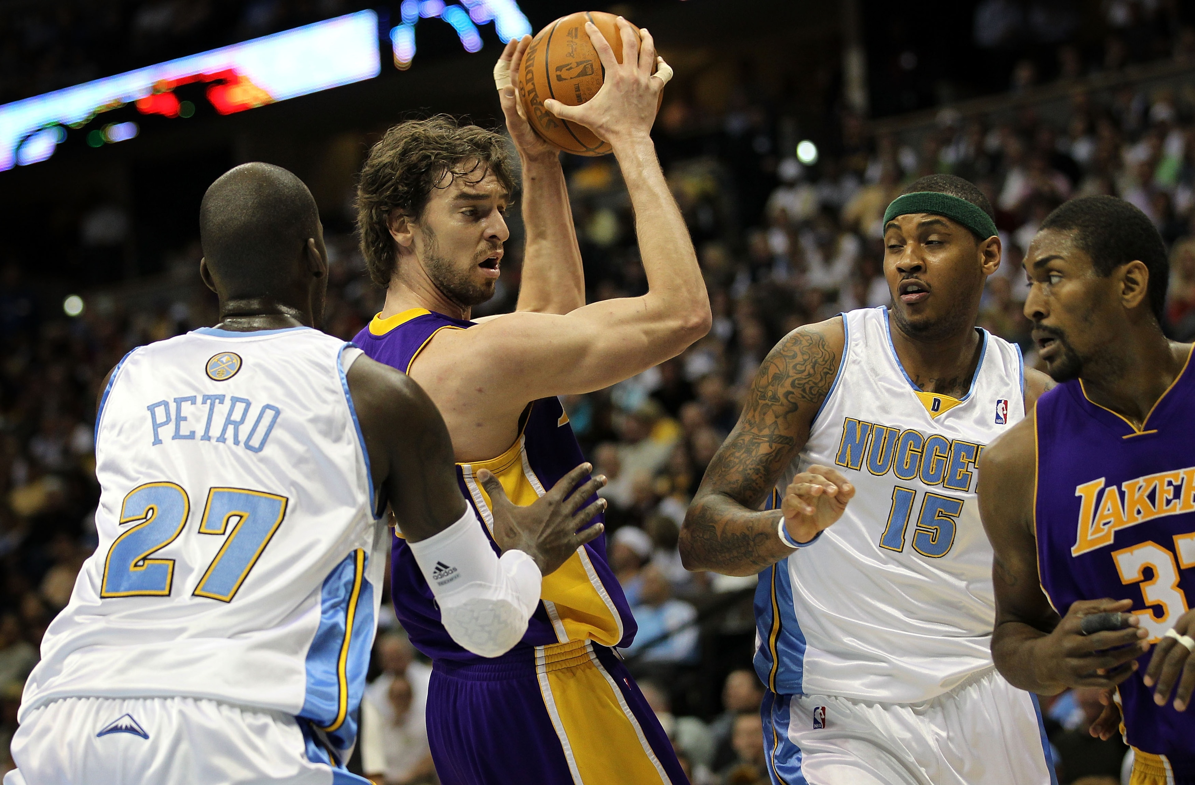DENVER - APRIL 08:  Pau Gasol #16 of the Los Angeles Lakers controls the ball as Johan Petro #27 of the Denver Nuggets defends while Carmelo Anthony #15 of the Nuggets defends against Ron Artest #37 of the Lakers during NBA action at the Pepsi Center on A