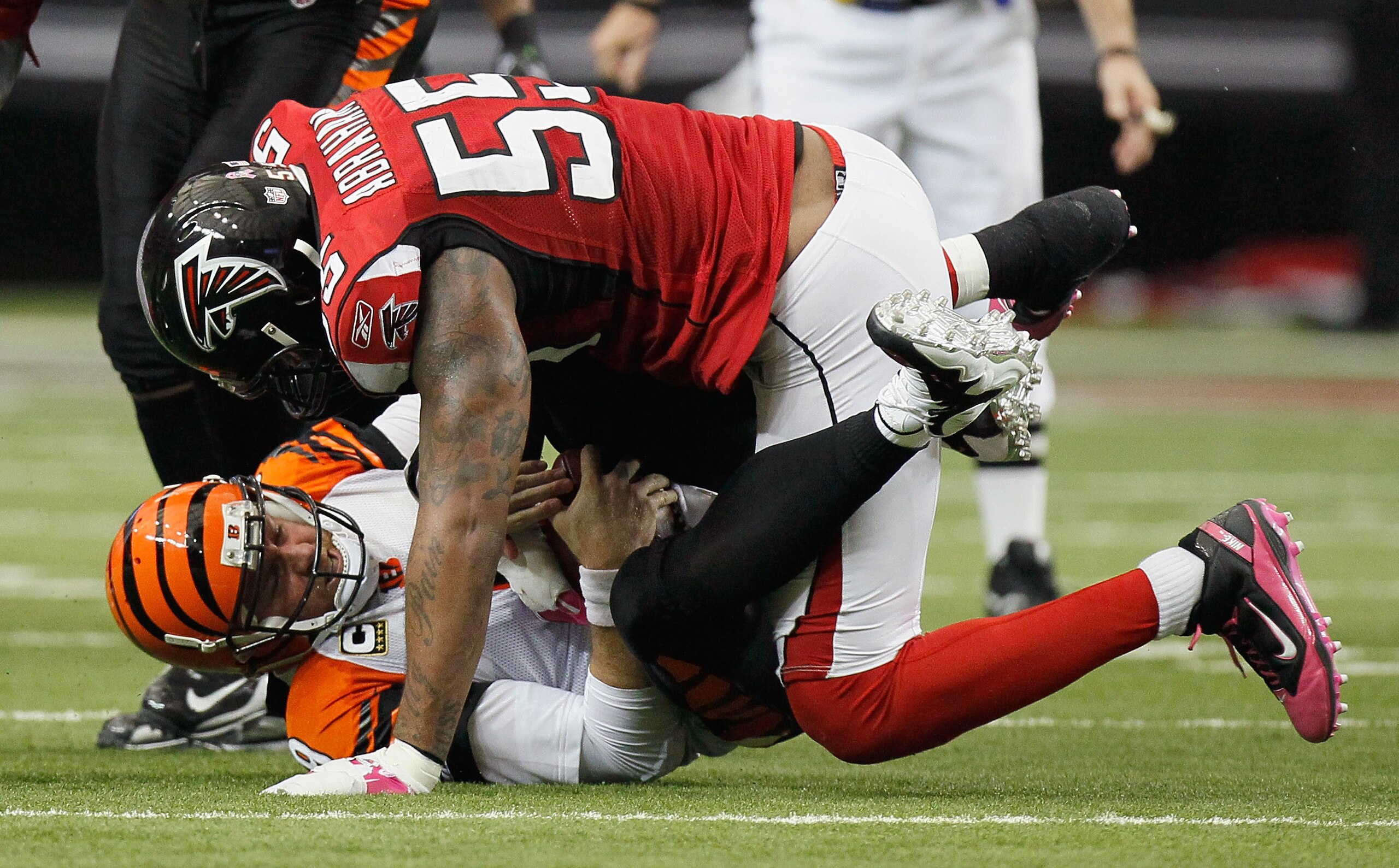 ATLANTA - OCTOBER 24:  Quarterback Carson Palmer #9 of the Cincinnati Bengals is sacked by John Abraham #55 of the Atlanta Falcons at Georgia Dome on October 24, 2010 in Atlanta, Georgia.  (Photo by Kevin C. Cox/Getty Images)