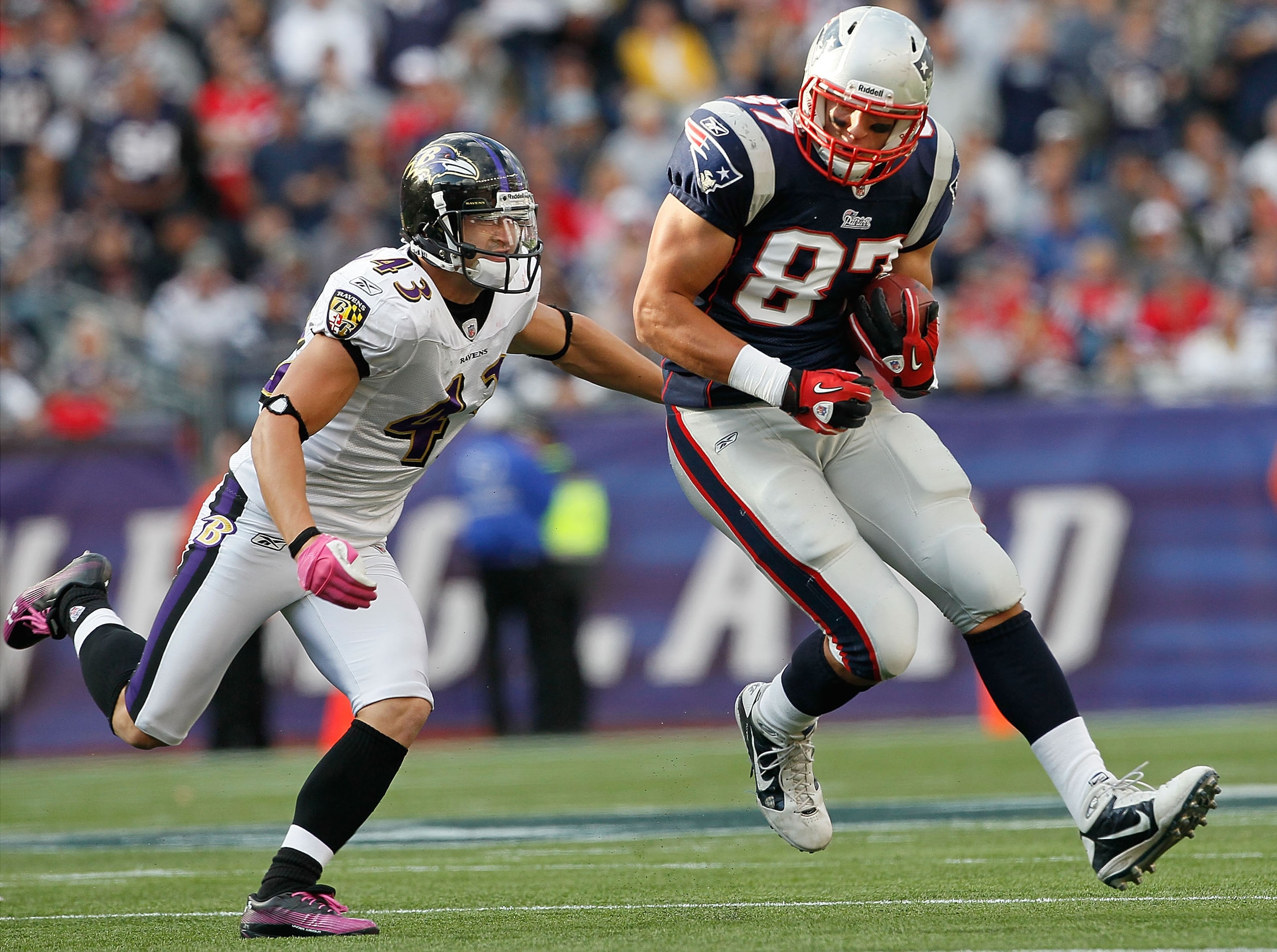 FOXBORO, MA - OCTOBER 17: Rob Gronkowski #87 of the New England Patriots gains yards as he is chased by Haruki Nakamura #43 of the Baltimore Ravens at Gillette Stadium on October 17, 2010 in Foxboro, Massachusetts. (Photo by Jim Rogash/Getty Images) FOXBORO, MA - OCTOBER 17: Rob Gronkowski #87 of the New England Patriots gains yards as he is chased by Haruki Nakamura #43 of the Baltimore Ravens at Gillette Stadium on October 17, 2010 in Foxboro, Massachusetts. (Photo by Jim Rogash/Getty Images)
