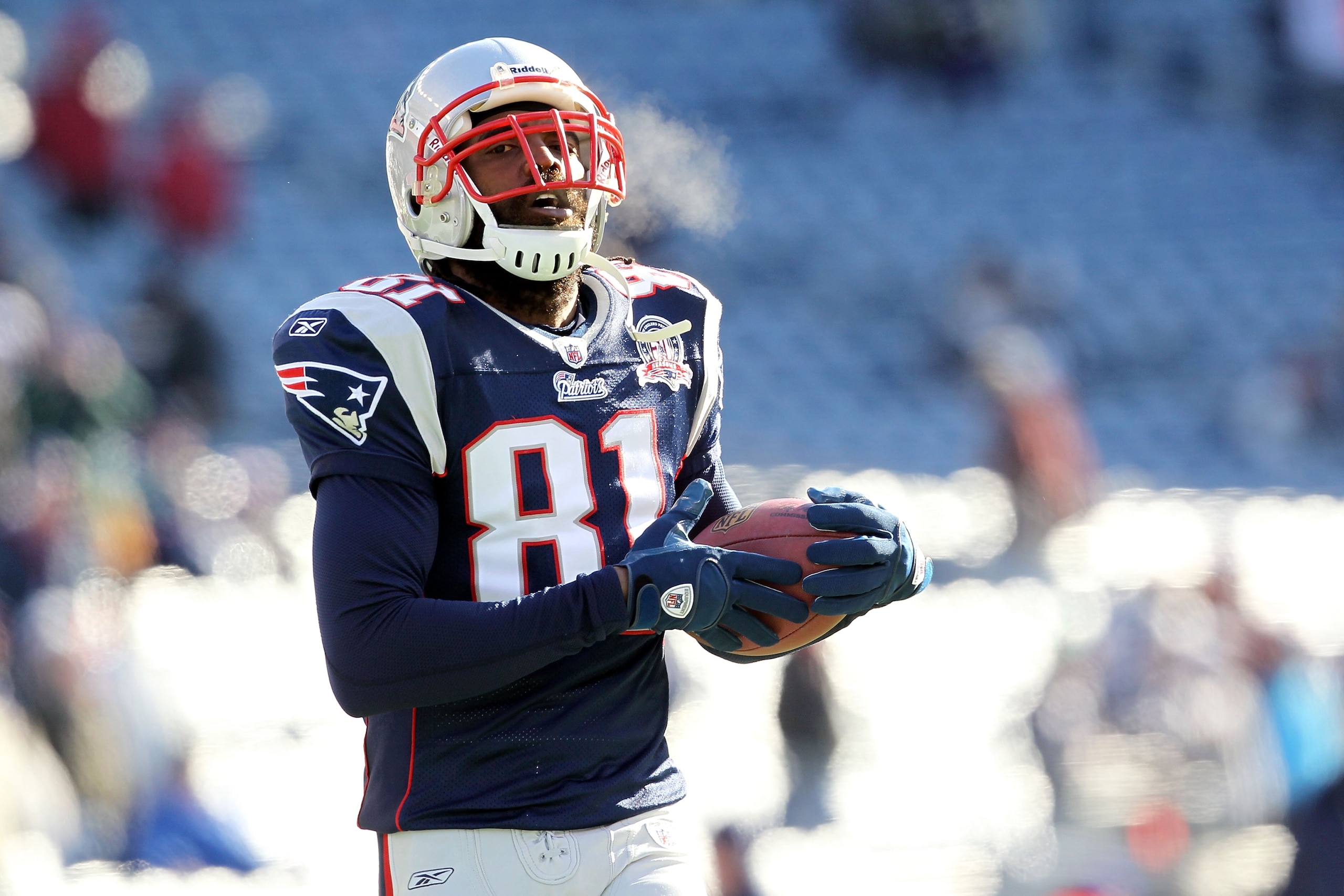 FOXBORO, MA - JANUARY 10:  Randy Moss #81 of the New England Patriots looks on during warm ups against the Baltimore Ravens during the 2010 AFC wild-card playoff game at Gillette Stadium on January 10, 2010 in Foxboro, Massachusetts.  (Photo by Jim Rogash