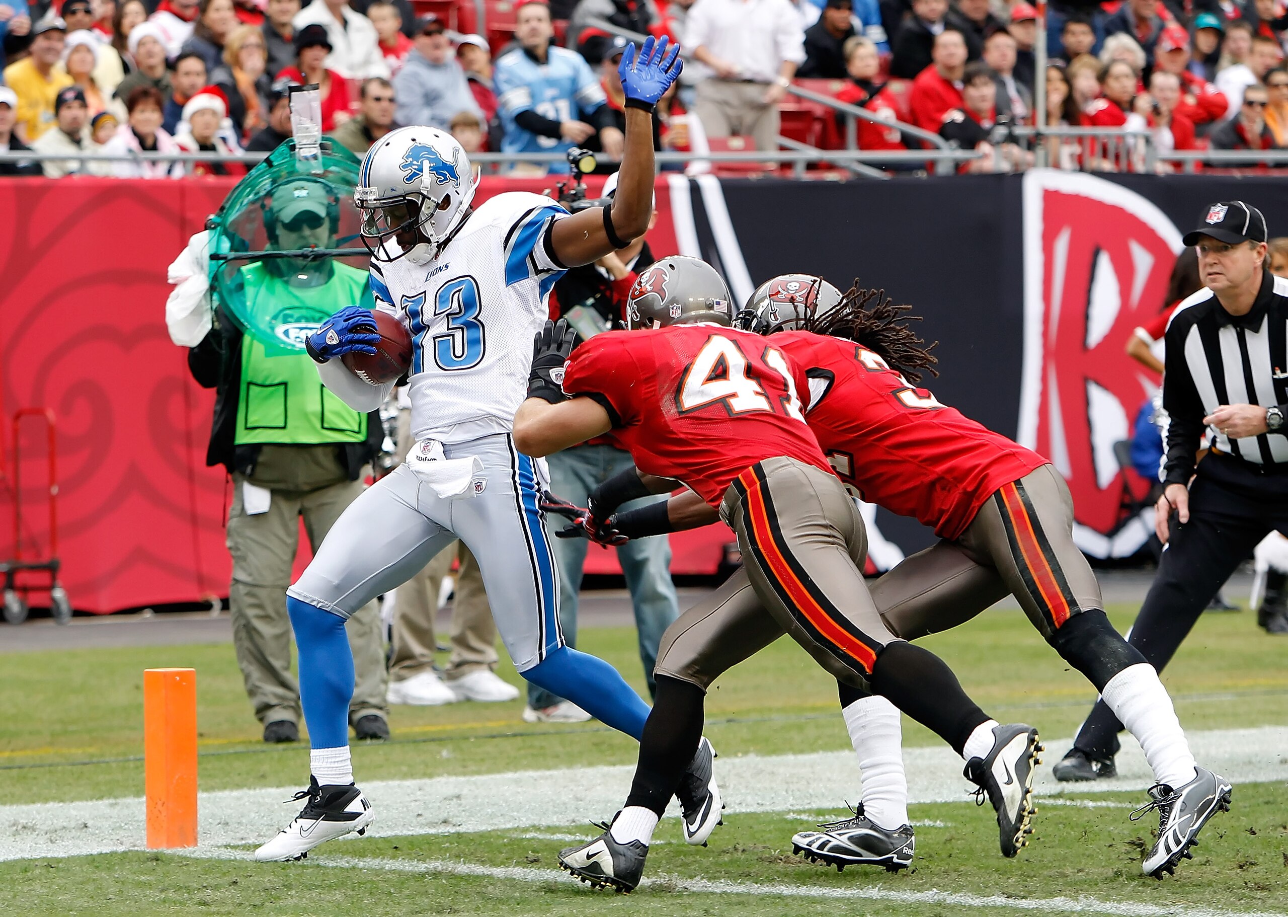TAMPA, FL - DECEMBER 19: Receiver Nate Burleson #13 of the Detroit Lions scores a touchdown in front of defenders Corey Lynch #41 and E.J. Biggers #31 of the Tampa Bay Buccaneers during the game at Raymond James Stadium on December 19, 2010 in Tampa, Flo TAMPA, FL - DECEMBER 19: Receiver Nate Burleson #13 of the Detroit Lions scores a touchdown in front of defenders Corey Lynch #41 and E.J. Biggers #31 of the Tampa Bay Buccaneers during the game at Raymond James Stadium on December 19, 2010 in Tampa, Flo