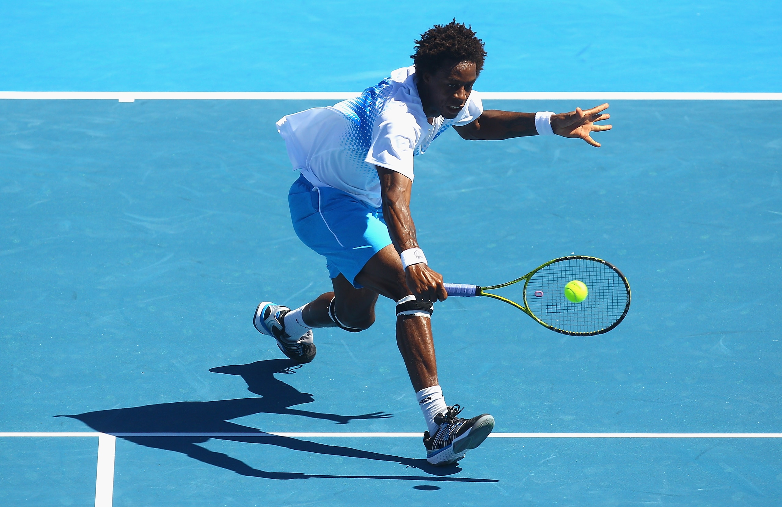MELBOURNE, AUSTRALIA - JANUARY 15:  Gael Monfils of France plays a backhand volley during his match against Lleyton Hewitt of Australia during day four of the AAMI Classic at Kooyong on January 15, 2011 in Melbourne, Australia.  (Photo by Quinn Rooney/Get