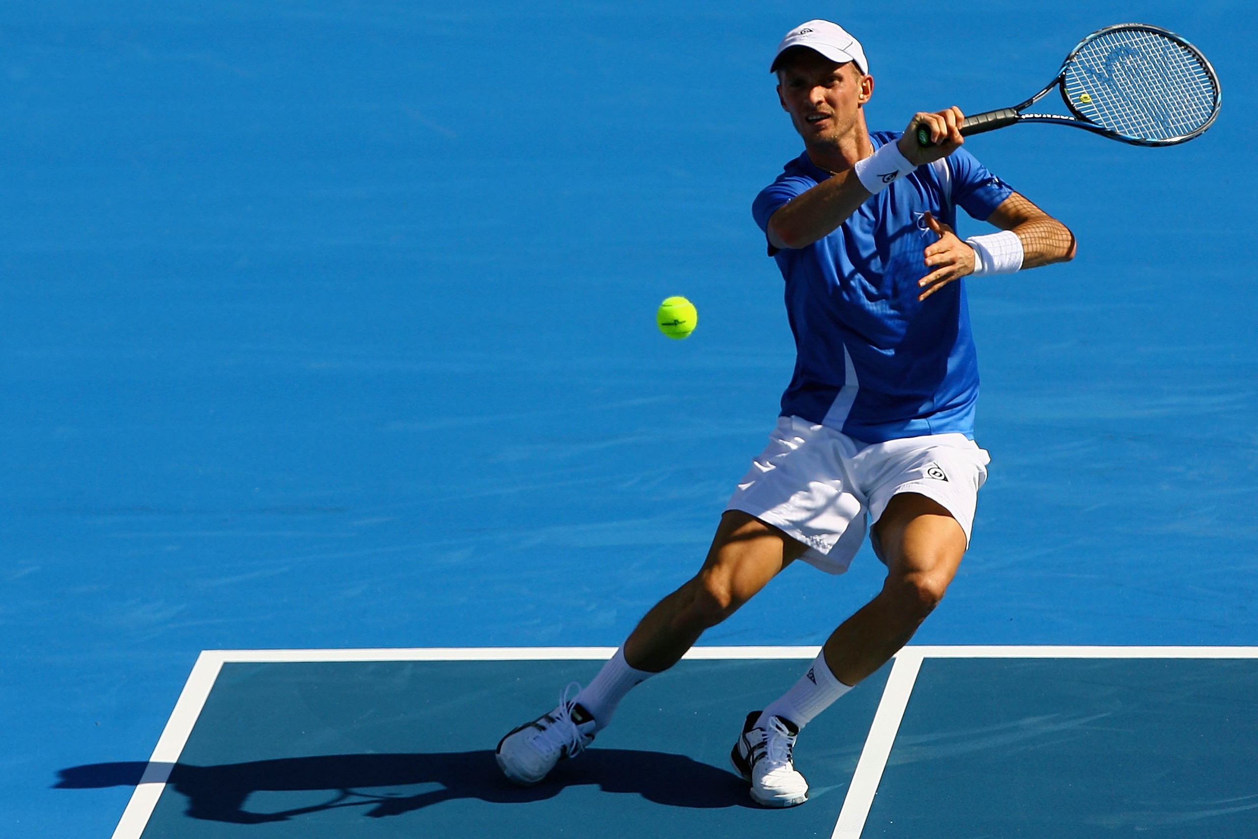 MELBOURNE, AUSTRALIA - JANUARY 14:  Nikolay Davydenko of Russia plays a forehand during his match against Lleyton Hewitt of Australia during day three of the AAMI Classic at Kooyong on January 14, 2011 in Melbourne, Australia.  (Photo by Robert Prezioso/G