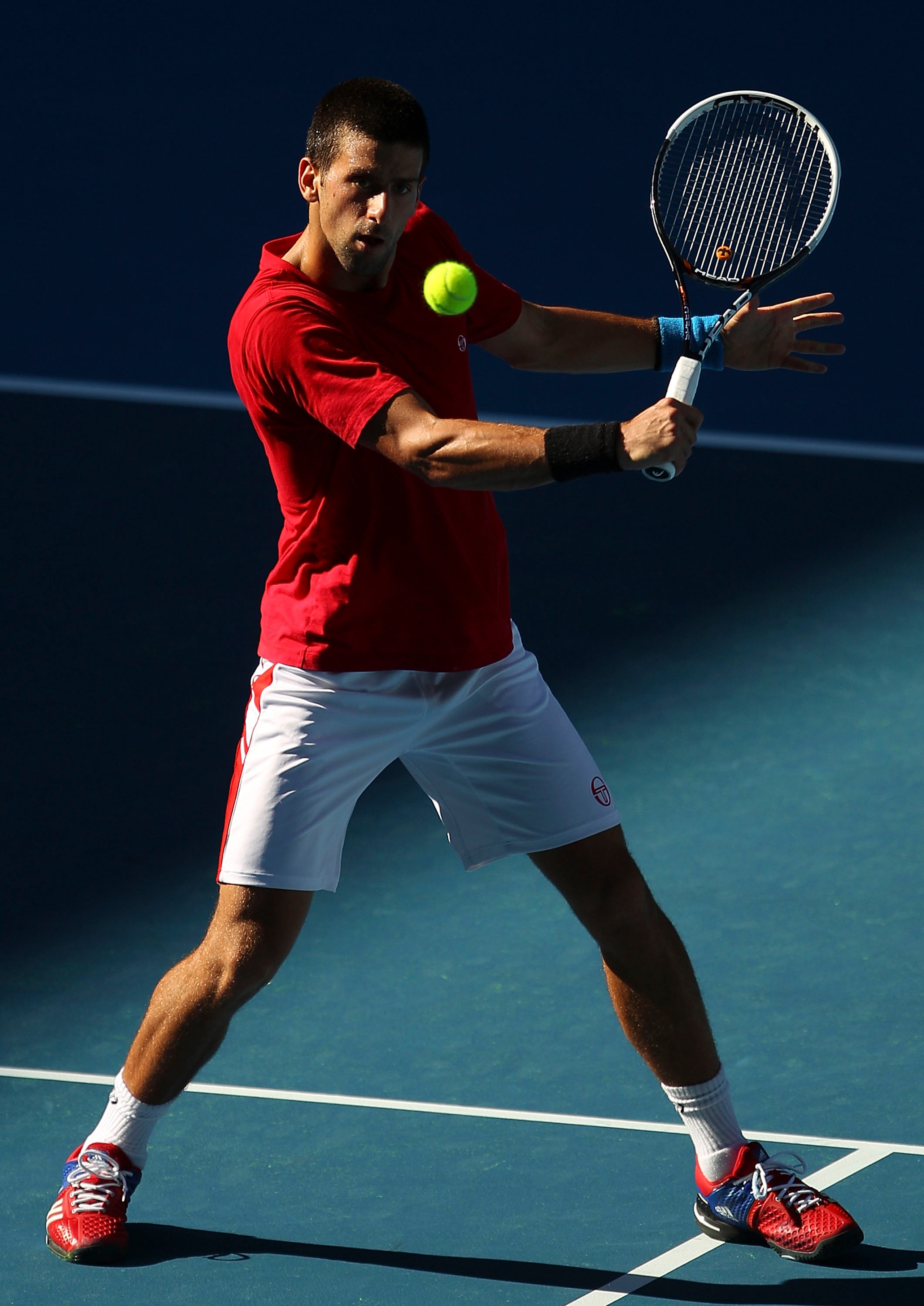 MELBOURNE, AUSTRALIA - JANUARY 14:  Novak Djokovic of Serbia hits a backhand shot during a practice session ahead of the 2011 Australian Open at Melbourne Park on January 14, 2011 in Melbourne, Australia.  (Photo by Lucas Dawson/Getty Images)