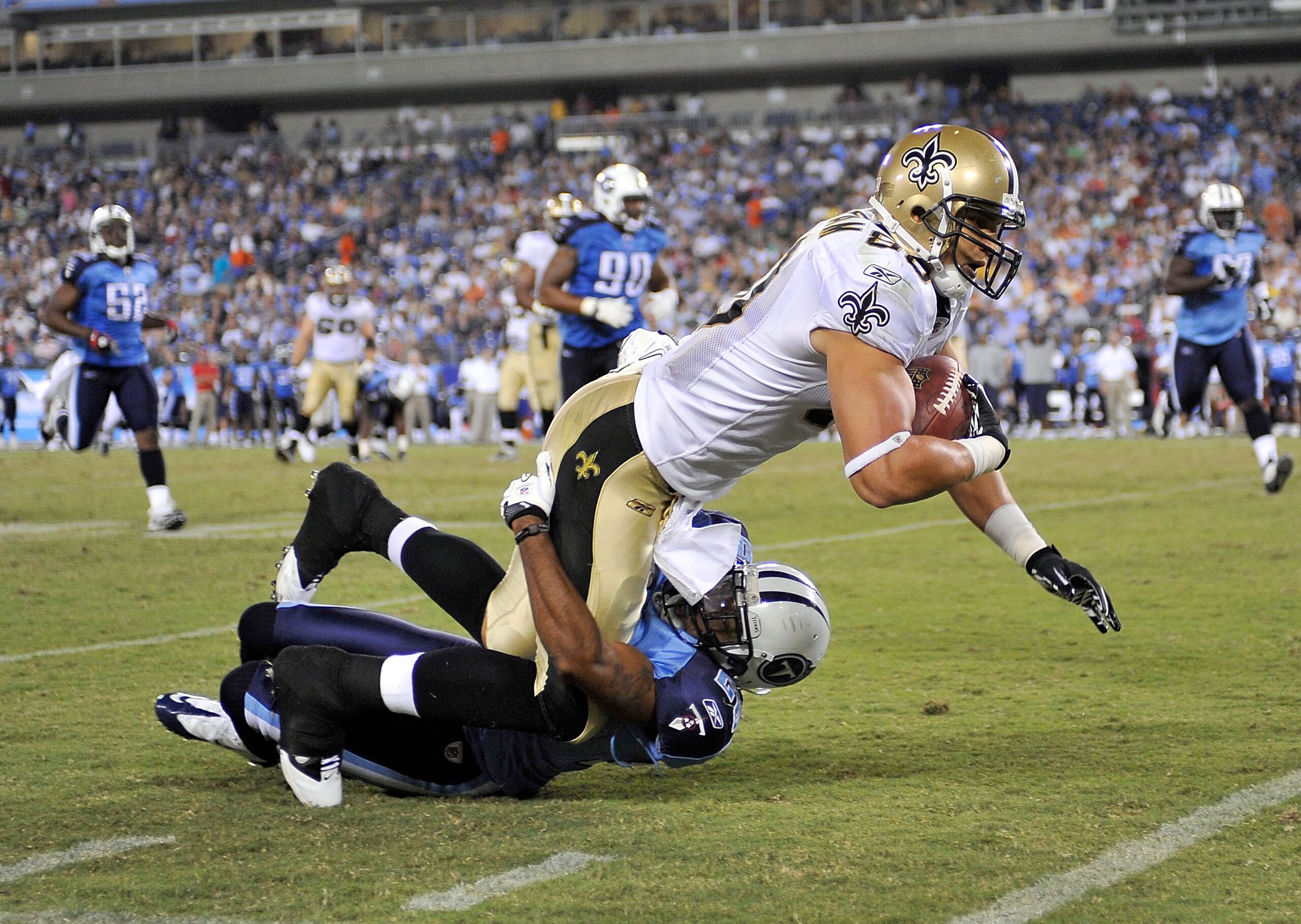 NASHVILLE, TN - SEPTEMBER 02:  Tye Hill #22  of the Tennessee Titans tackles Jimmy Graham #80 of the New Orleans Saints during an exhibition game at LP Field on September 2, 2010 in Nashville, Tennessee. Tennessee won 27-24.  (Photo by Grant Halverson/Get