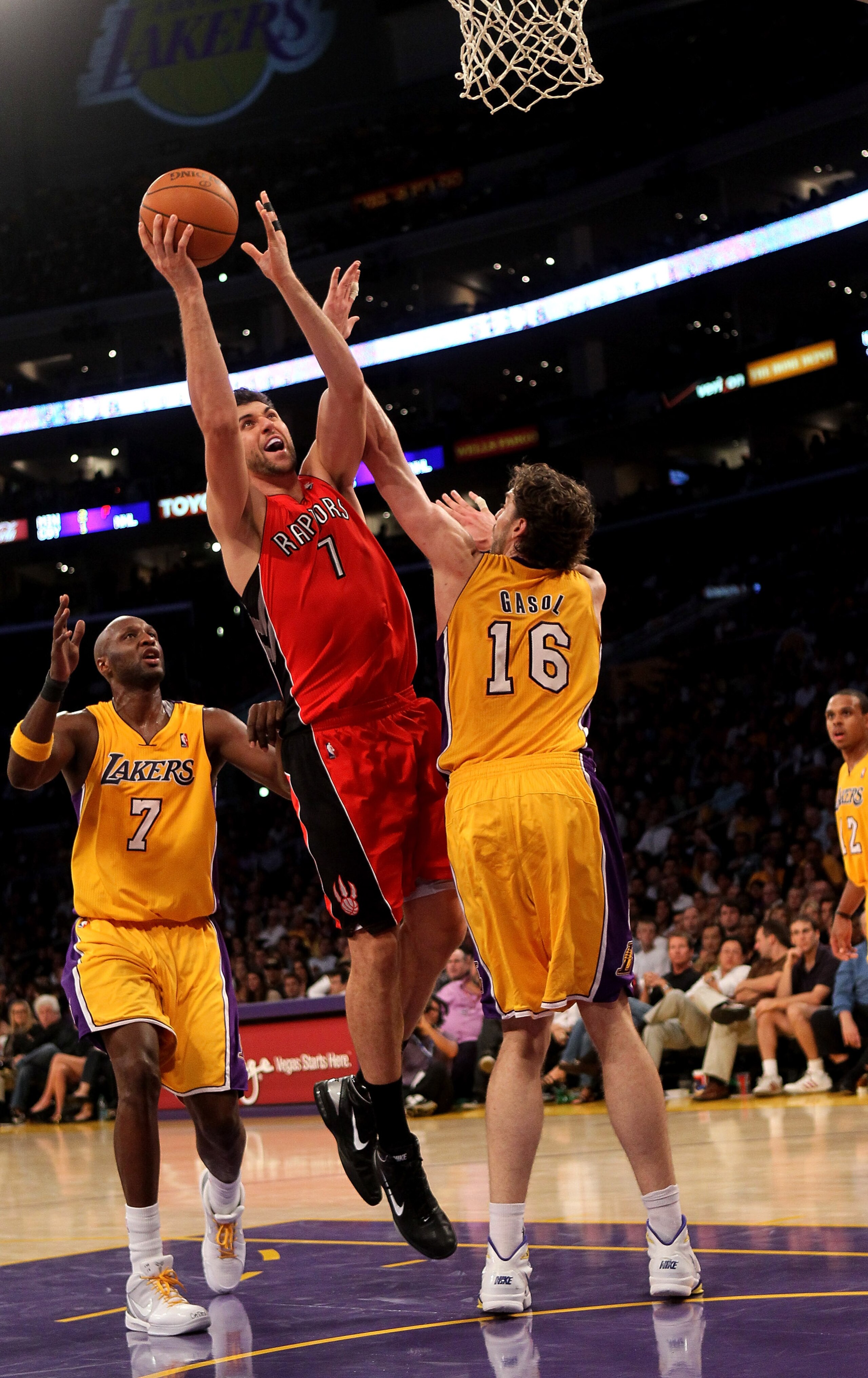 LOS ANGELES - NOVEMBER 5:  Andrea Bargnani #7 of the Toronto Raptors shoots over Pau Gasol #16 and Lamar Odom #7 of the Los Angeles Lakers at Staples Center on November 5, 2010 in Los Angeles, California.  The Lakers won 108-102.   NOTE TO USER: User expr