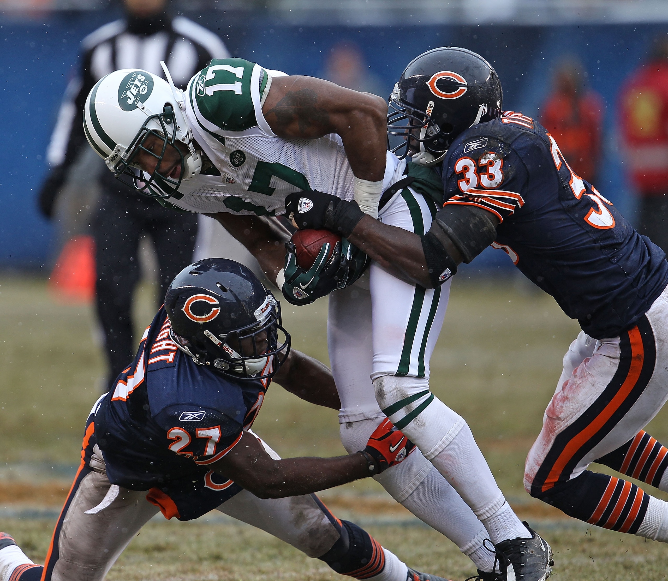 CHICAGO, IL - DECEMBER 26: Braylon Edwards #17 of the New York Jets is tackled by Major Wright #27 and Charles Tillman #33 of the Chicago Bears at Soldier Field on December 26, 2010 in Chicago, Illinois. The Bears defeated the Jets 38-34. (Photo by Jonath