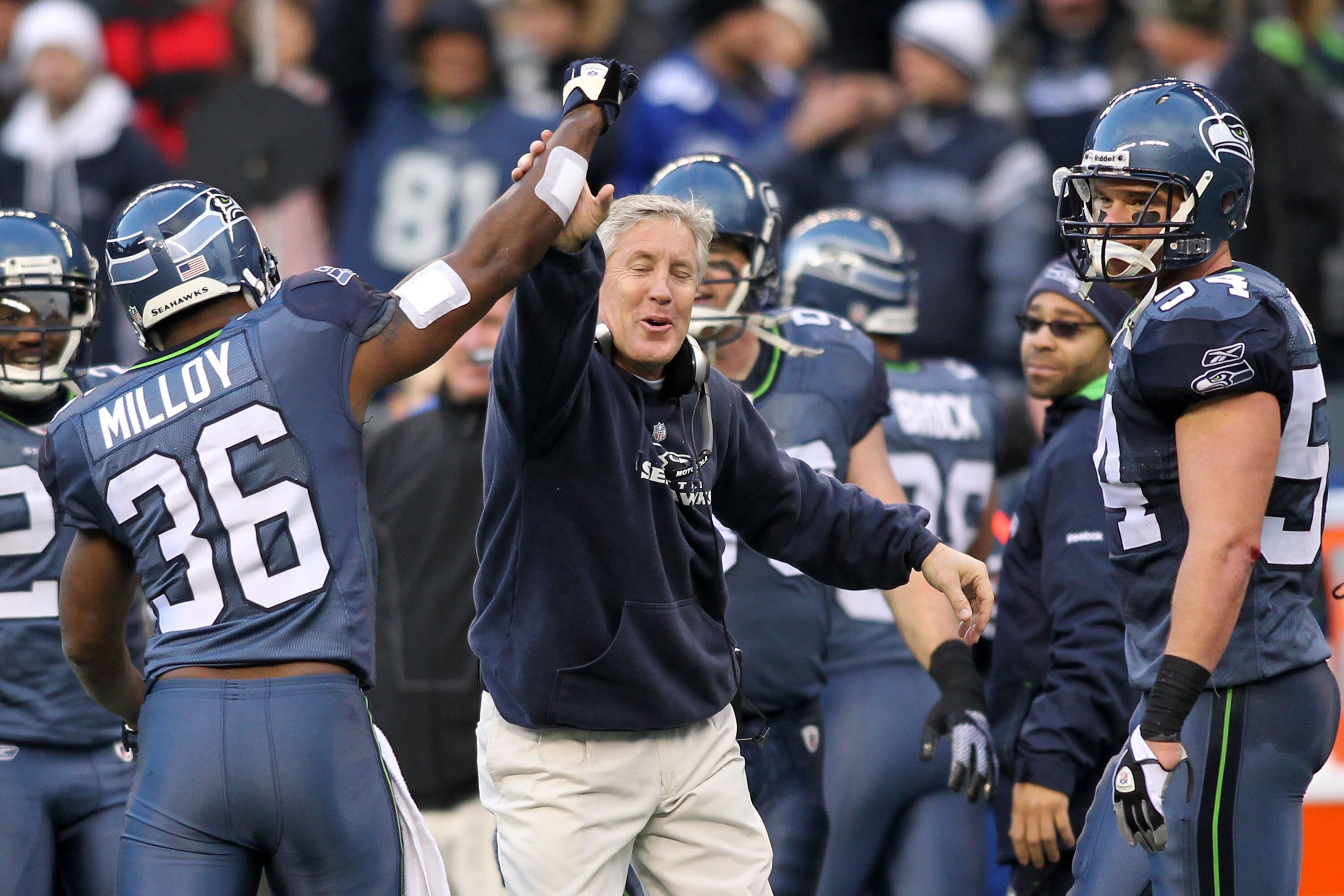 SEATTLE, WA - JANUARY 08: Head coach Pete Carroll and Lawyer Milloy #36 of the Seattle Seahawks celebrate a fourth down stop by the Seahawks in the third quarter against the New Orleans Saints during the 2011 NFC wild-card playoff game at Qwest Field on J