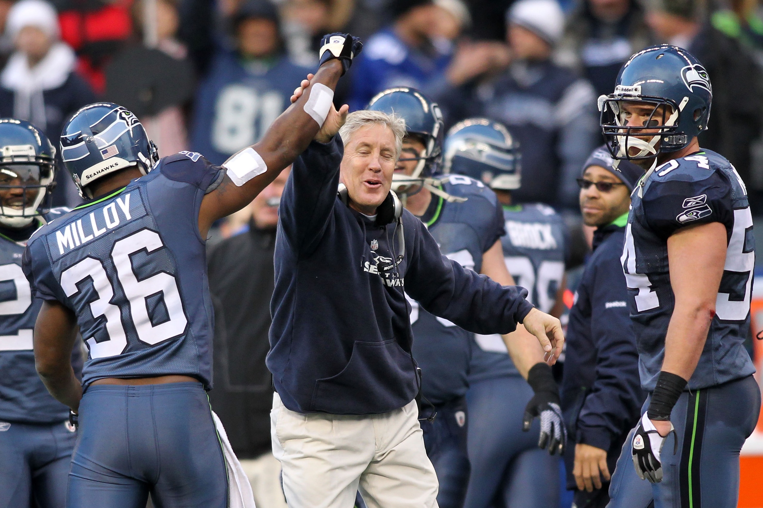 SEATTLE, WA - JANUARY 08: Head coach Pete Carroll and Lawyer Milloy #36 of the Seattle Seahawks celebrate a fourth down stop by the Seahawks in the third quarter against the New Orleans Saints during the 2011 NFC wild-card playoff game at Qwest Field on J