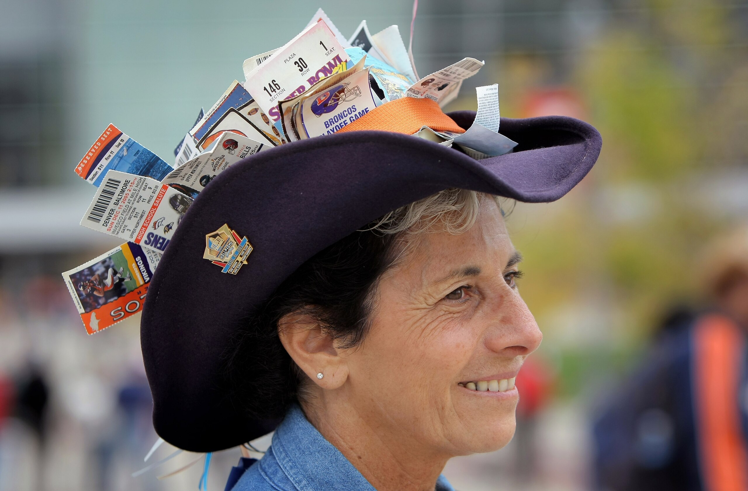 DENVER - SEPTEMBER 14:  Sherri Adams, of Arvada, Colorado enters the staduim as the San Diego Chargers face the Denver Broncos during NFL action at Invesco Field at Mile High on September 14, 2008 in Denver, Colorado. Adams hat has tickets displayed from