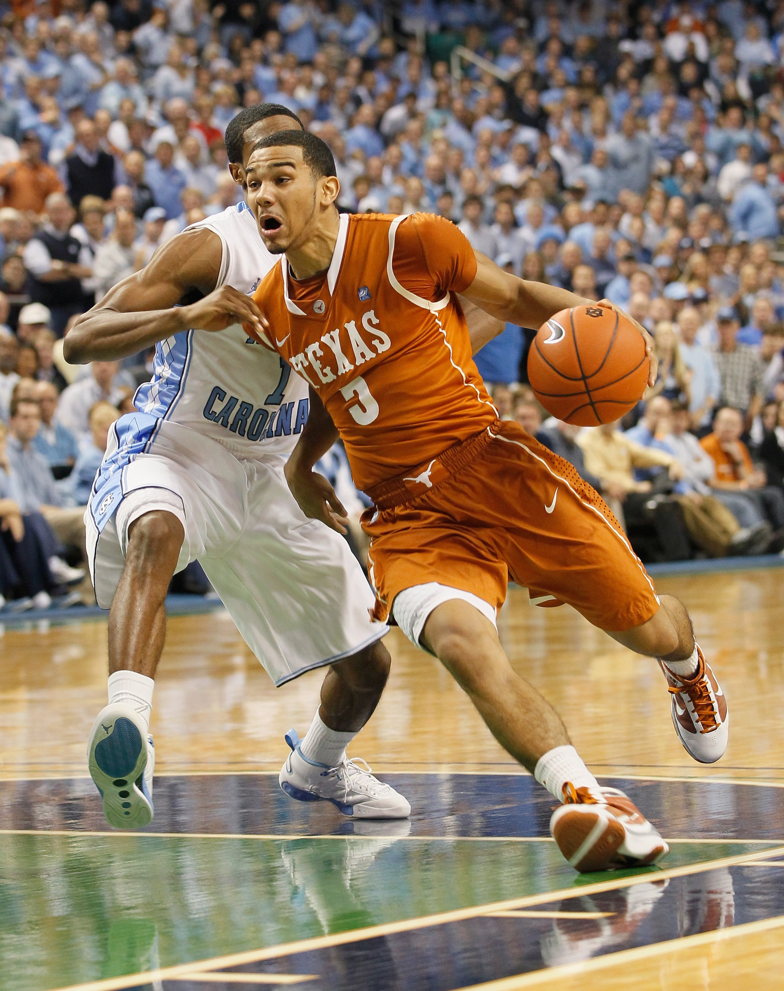 GREENSBORO, NC - DECEMBER 18:  Cory Joseph #5 of the Texas Longhorns drives around Dexter Strickland #1 of the North Carolina Tar Heels at Greensboro Coliseum on December 18, 2010 in Greensboro, North Carolina.  (Photo by Kevin C. Cox/Getty Images)