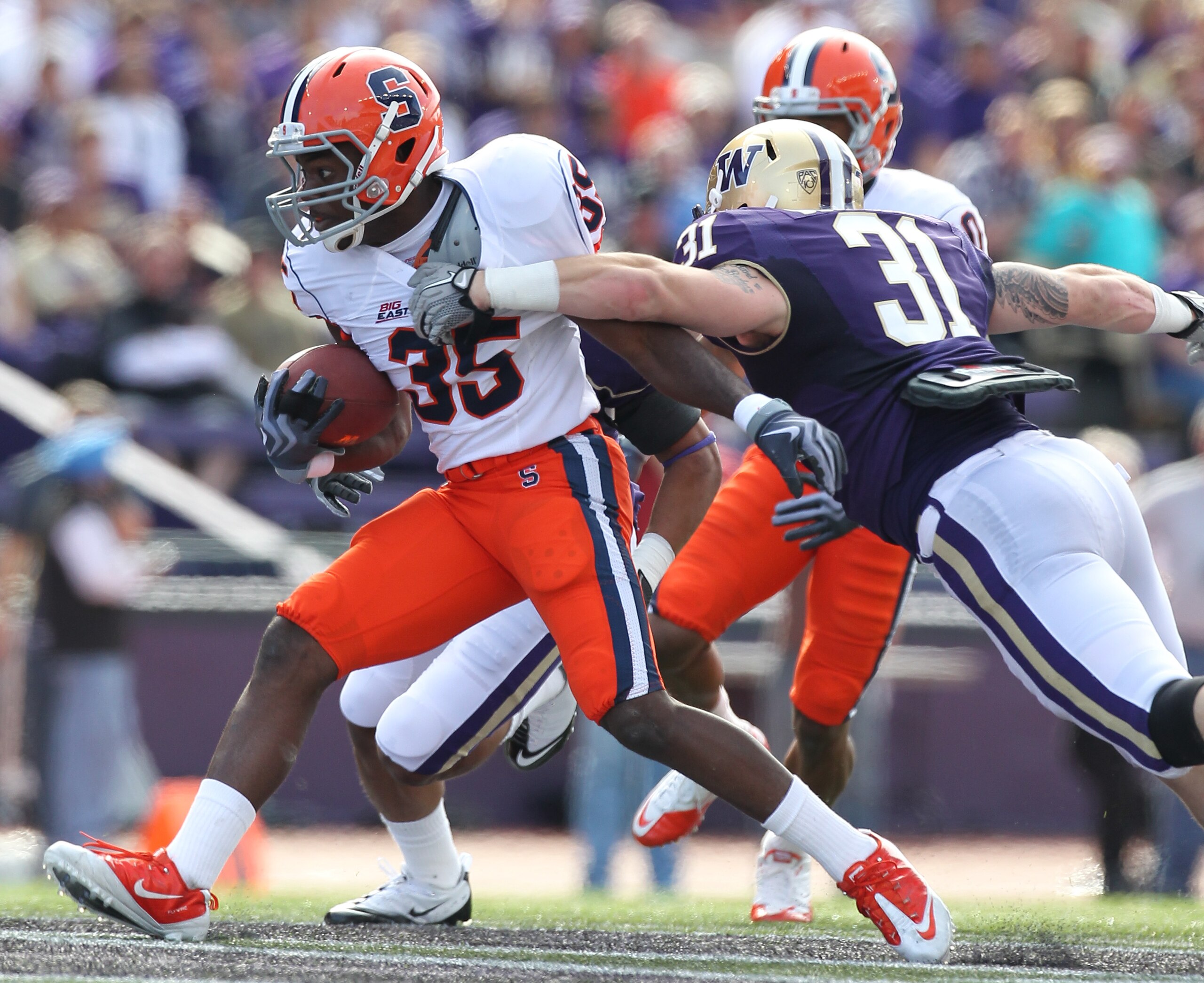 SEATTLE - SEPTEMBER 11:  Mike Holmes #35 of the Syracuse Orange rushes against Cort Dennison #31 of the Washington Huskies on September 11, 2010 at Husky Stadium in Seattle, Washington. (Photo by Otto Greule Jr/Getty Images)