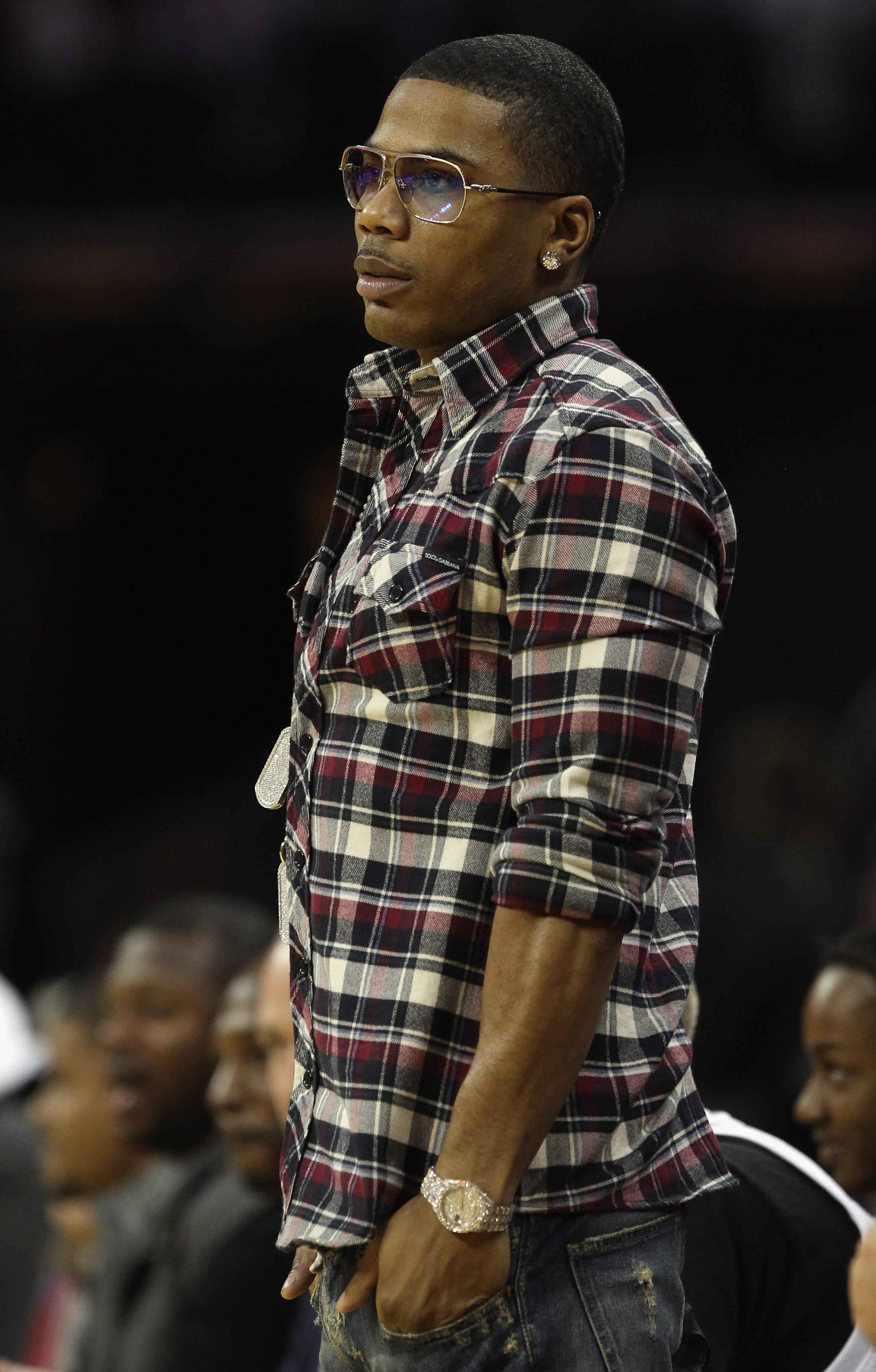 CHARLOTTE, NC - NOVEMBER 08:  Recording Artist, Nelly, cheers on during the game between the San Antonio Spurs and the Charlotte Bobcats at Time Warner Cable Arena on November 8, 2010 in Charlotte, North Carolina.  NOTE TO USER: User expressly acknowledge