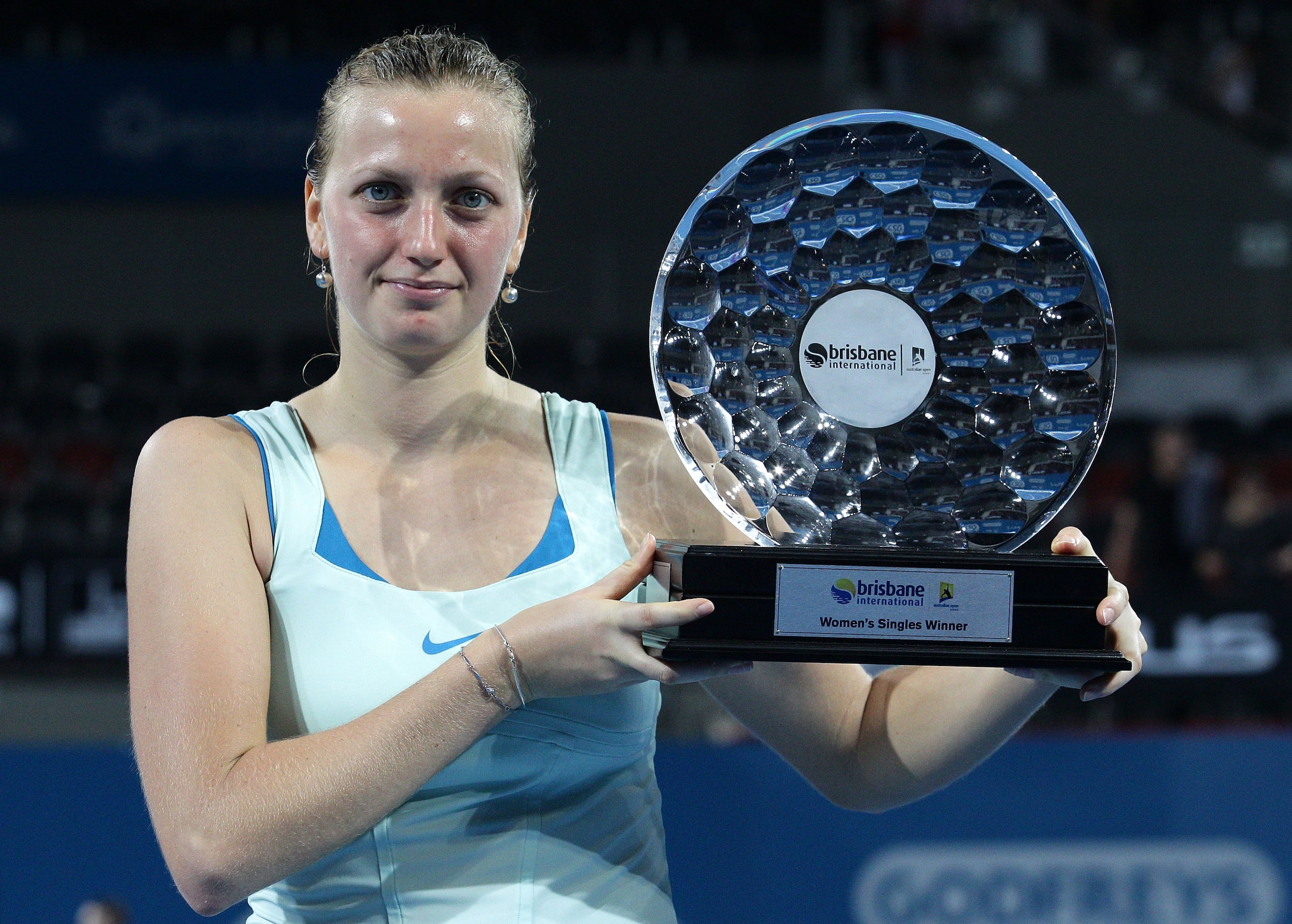BRISBANE, AUSTRALIA - JANUARY 08:  Petra Kvitova of the Czech Republic holds the winners trophy as she celebrates victory after her finals match against Andrea Petkovic of Germany during day seven of the Brisbane International at the Queensland Tennis Cen