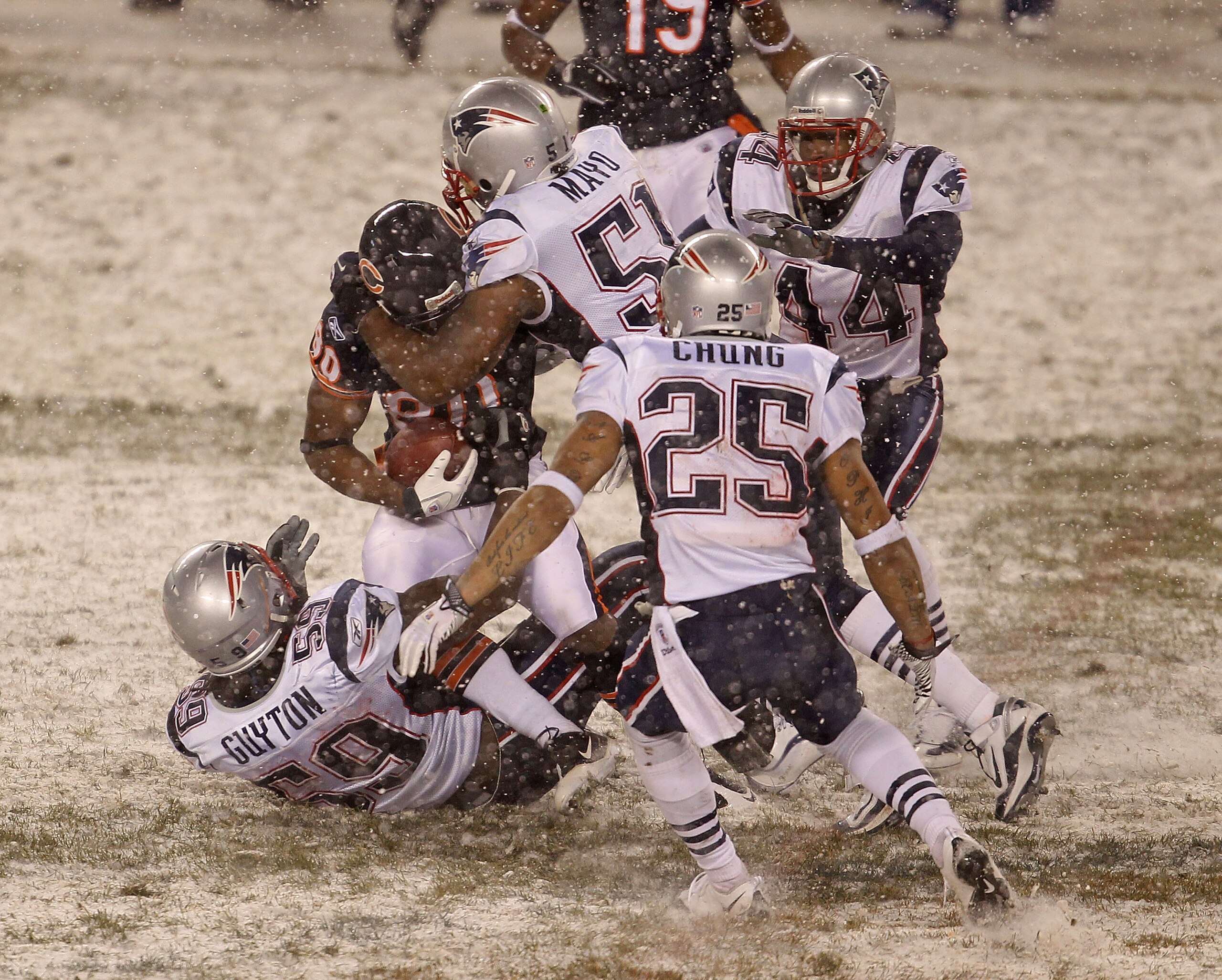 CHICAGO - DECEMBER 12: Earl Bennett #80 of the Chicago Bears is gang-tackled by Gary Guyton #59, Jerod Mayo #51, Patrick Chung #25 and Jarred Page #44 of the New England Patriots at Soldier Field on December 12, 2010 in Chicago, Illinois. The Patriots def