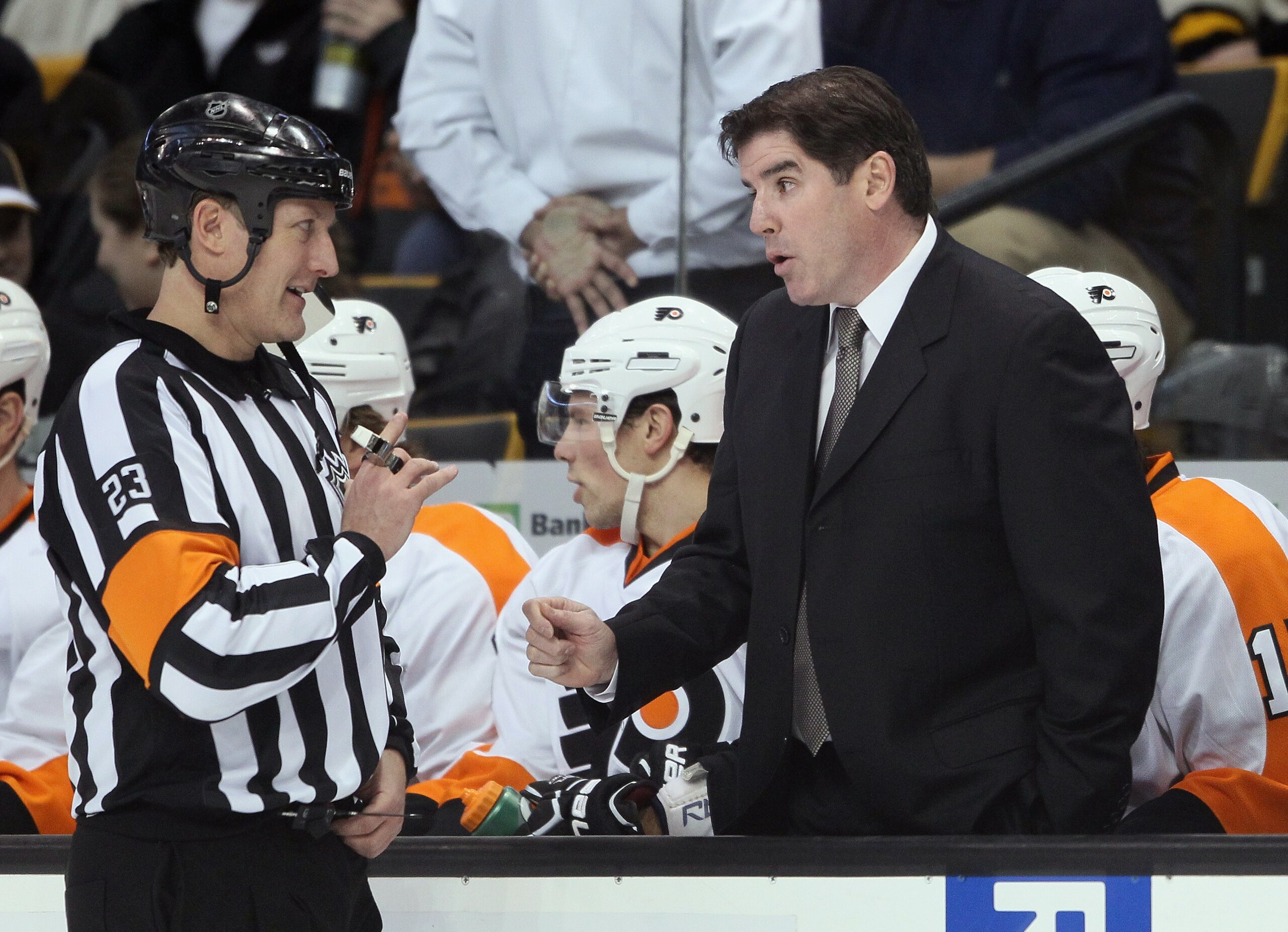 BOSTON, MA - JANUARY 13:  Head coach Peter Laviolette of the Philadelphia Flyers talks with referee Brad Watson before the start of the second period against the Boston Bruins on January 11, 2011 at the TD Garden in Boston, Massachusetts.  (Photo by Elsa/