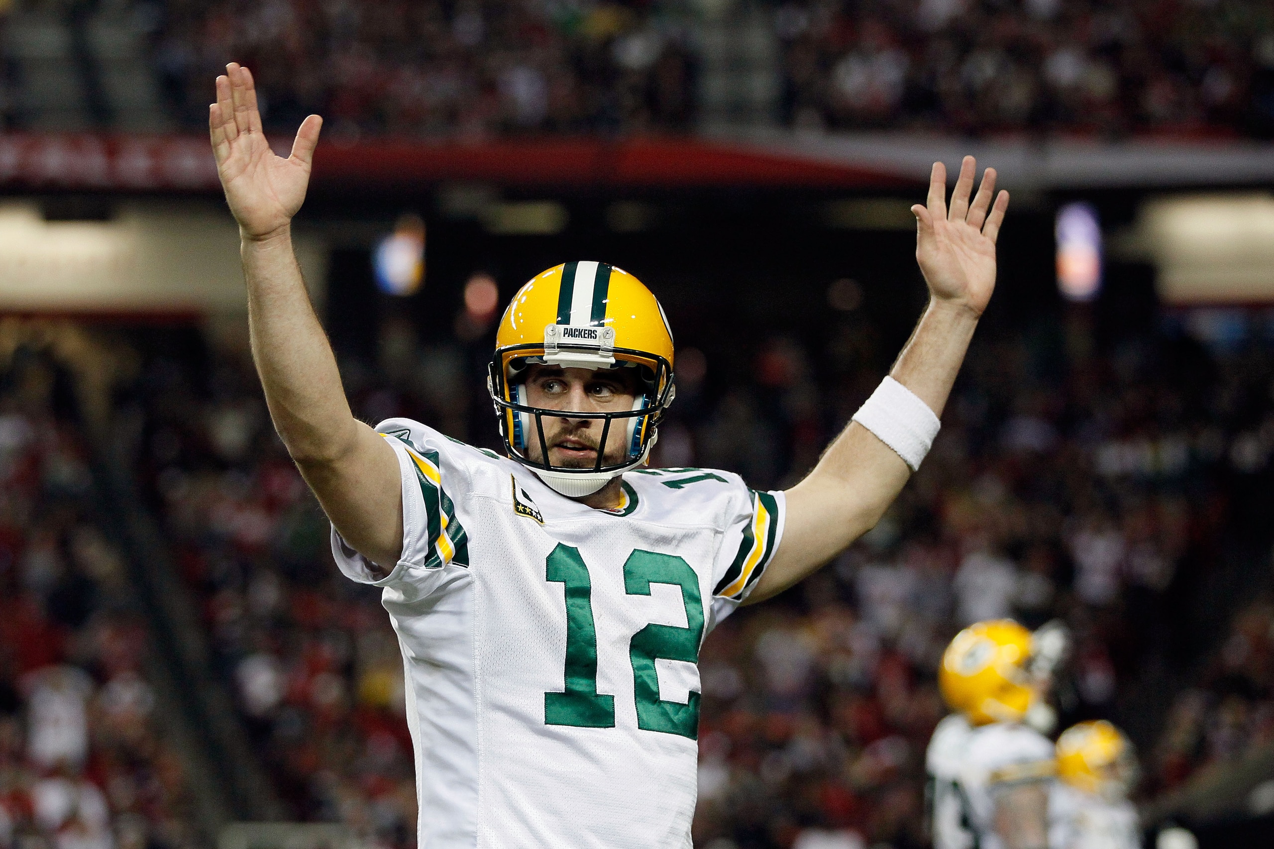 ATLANTA, GA - JANUARY 15: Aaron Rodgers #12 of the Green Bay Packers reacts after he threw a 7-yard touchdown to John Kuhn #30 in the third quarter against the Atlanta Falcons during their 2011 NFC divisional playoff game at Georgia Dome on January 15, 2 ATLANTA, GA - JANUARY 15: Aaron Rodgers #12 of the Green Bay Packers reacts after he threw a 7-yard touchdown to John Kuhn #30 in the third quarter against the Atlanta Falcons during their 2011 NFC divisional playoff game at Georgia Dome on January 15, 2