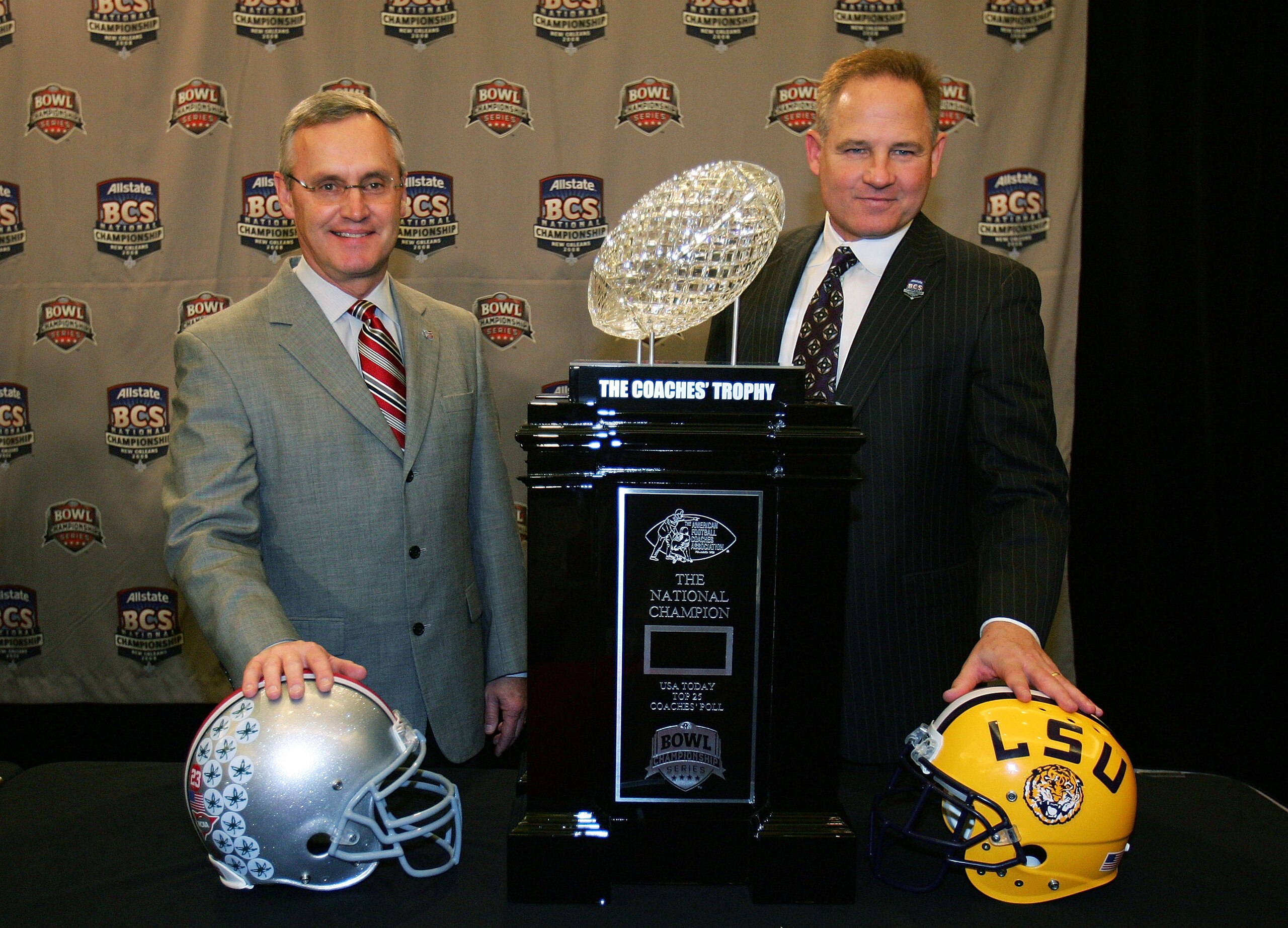 NEW ORLEANS - JANUARY 06:  Ohio State Head coach Jim Tressel and Louisiana State Head coach Les Miles pose with the BCS trophy during the BCS Championship coaches' press conference on January 6, 2008 in New Orleans, Louisiana.  Louisiana State will take o