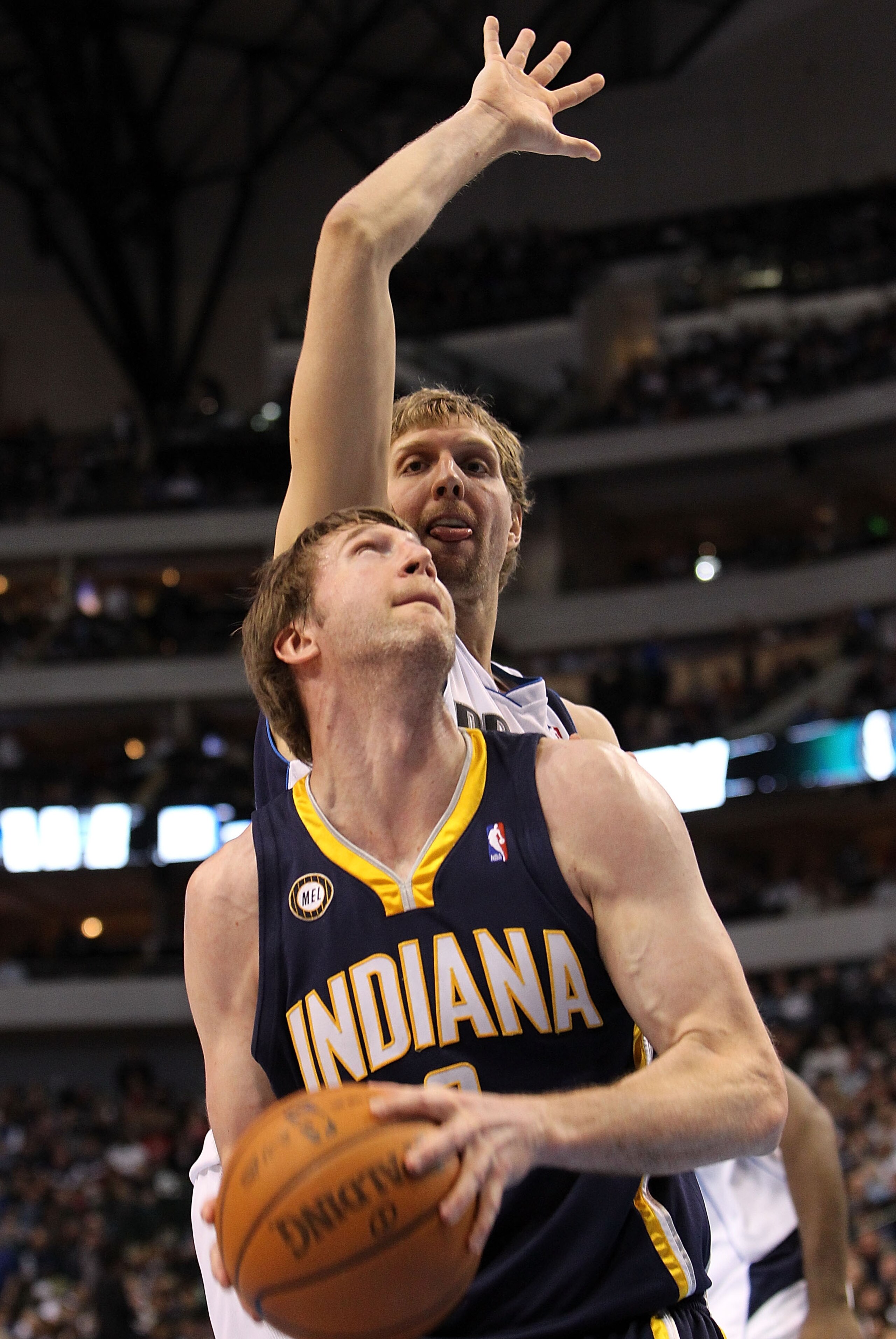 DALLAS - FEBRUARY 22:  Forward Troy Murphy #3 of the Indiana Pacers takes a shot against Dirk Nowitzki #41 of the Dallas Mavericks on February 22, 2010 at American Airlines Center in Dallas, Texas.  NOTE TO USER: User expressly acknowledges and agrees tha