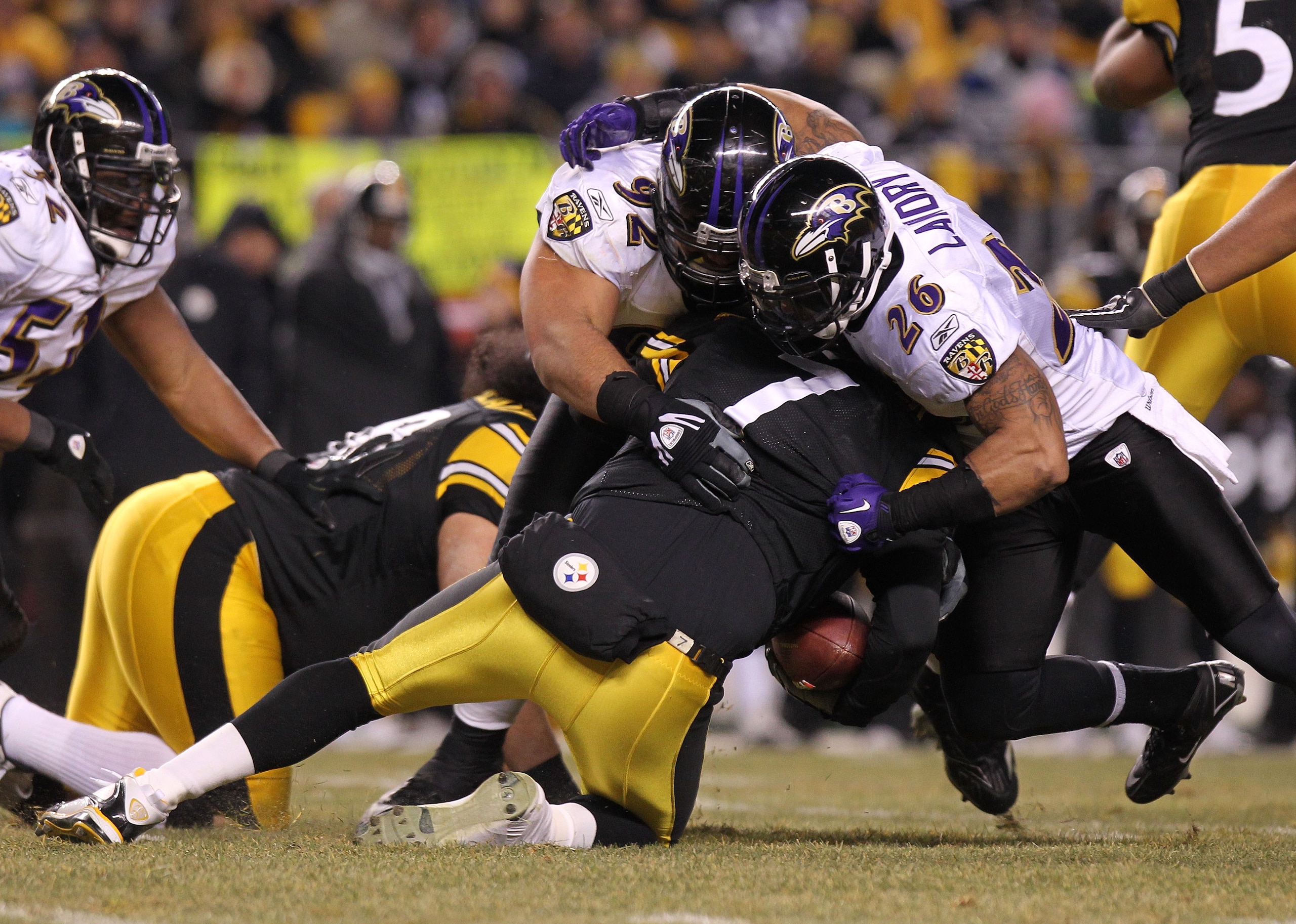 PITTSBURGH, PA - JANUARY 15:  Quarterback Ben Roethlisberger #7 of the Pittsburgh Steelers is sacked by safety Dawan Landry #26 and defensive tackle Haloti Ngata #92 of the Baltimore Ravens during the AFC Divisional Playoff Game at Heinz Field on January
