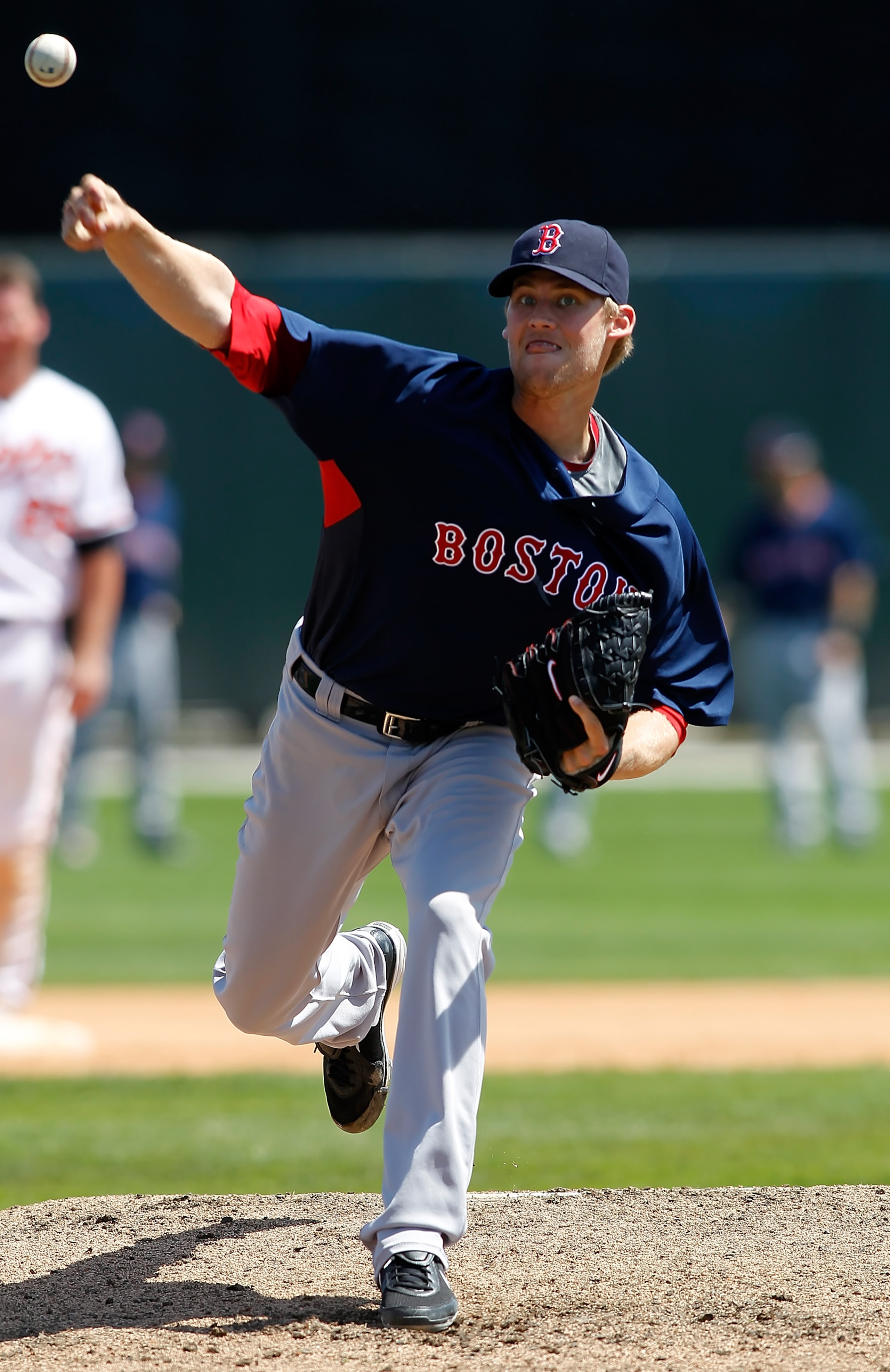 SARASOTA, FL - MARCH 27:  Pitcher Daniel Bard #51 of the Boston Red Sox loosens up in the dugout against the Baltimore Orioles during a Grapefruit League Spring Training Game at Ed Smith Stadium on March 27, 2010 in Sarasota, Florida.  (Photo by J. Meric/