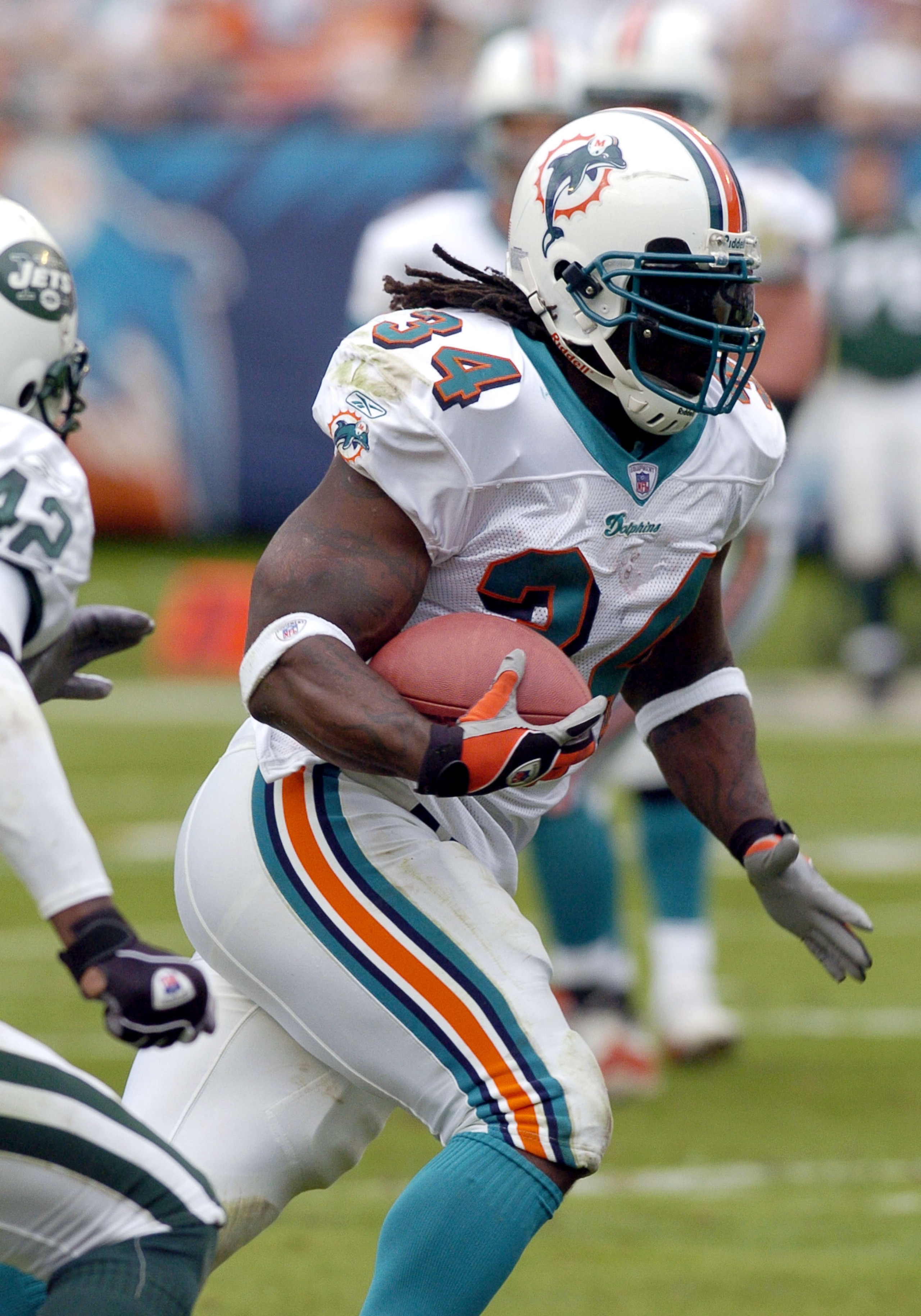 Miami Dolphins running back  Ricky Williams  rushes to midfield  December 28, 2003 at Pro Player Stadium, Miami, Florida.  Williams scored a touchdown and the Dolphins defeated the New York Jets 23 - 21.  (Photo by Al Messerschmidt/Getty Images)